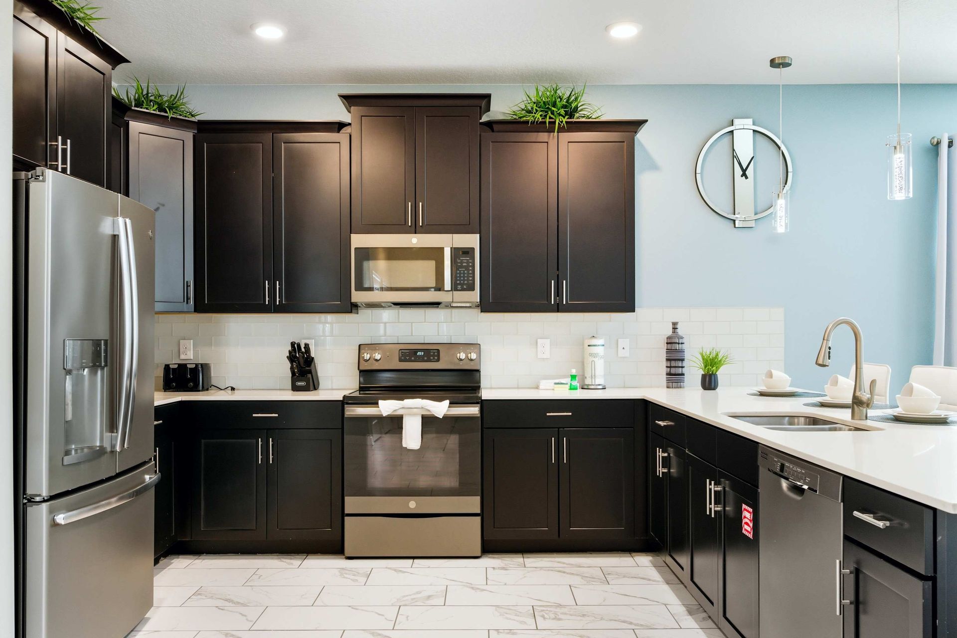 Stylish kitchen with dark wood and clean white countertops.