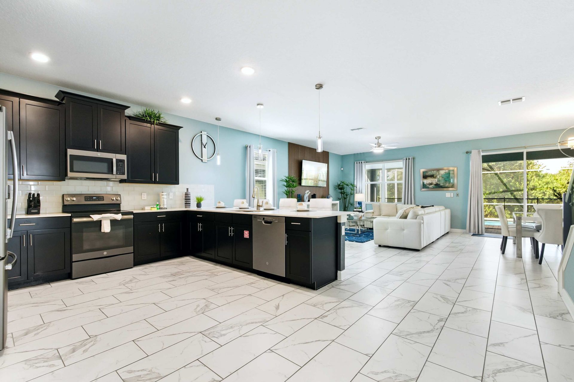 Fully equipped, modern kitchen with stainless steel and breakfast bar.