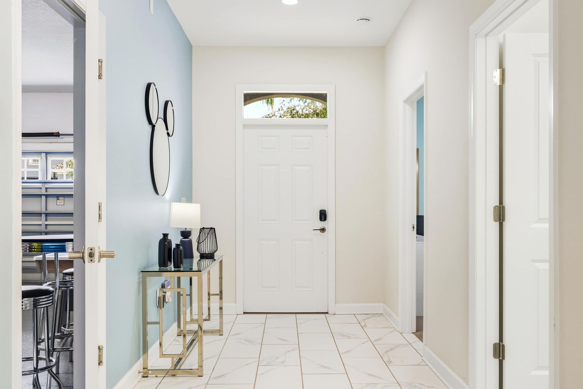 Bright tiled hallway opens into the living area with soft, natural light.