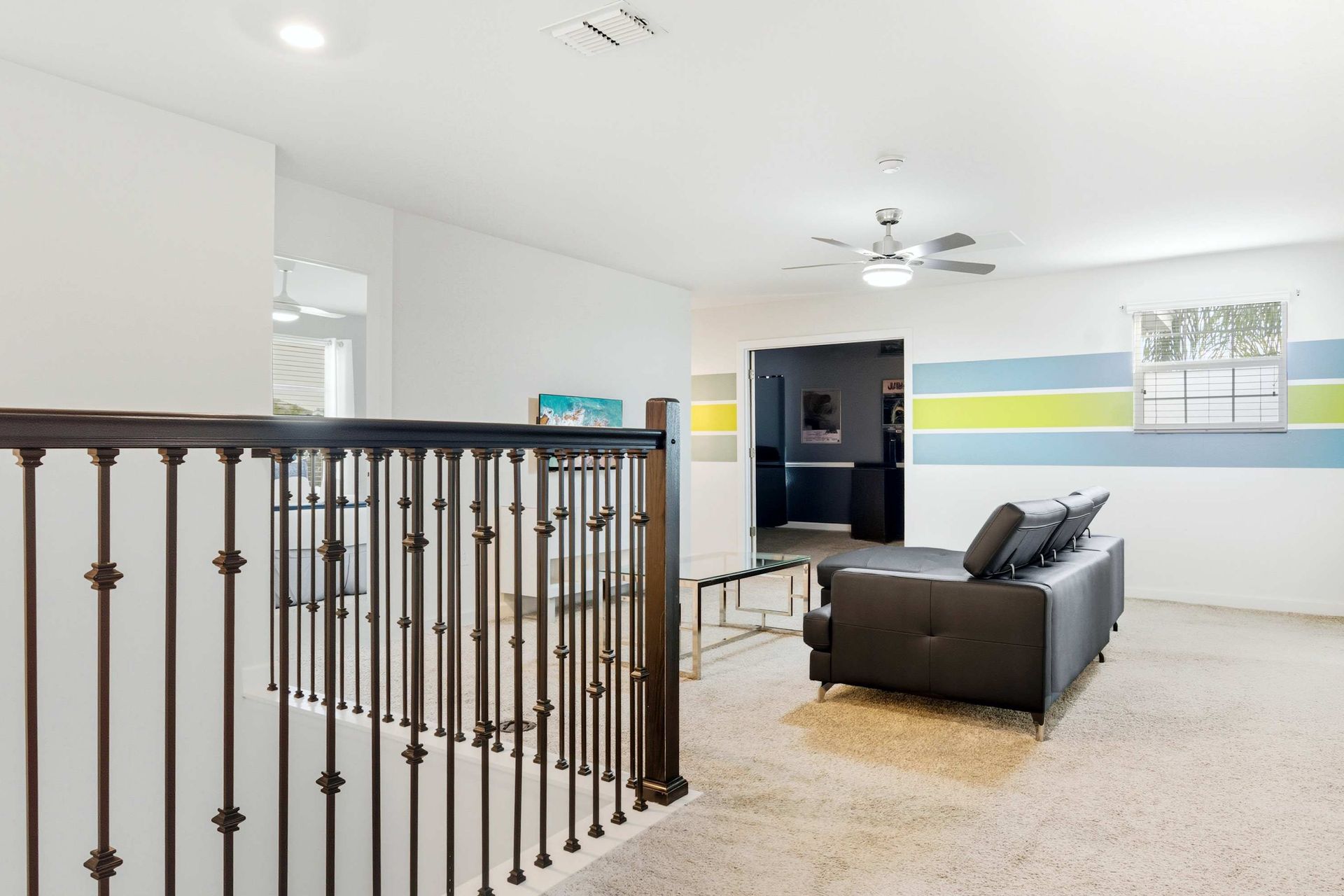 Second-floor lounge with comfy sectional and TV.