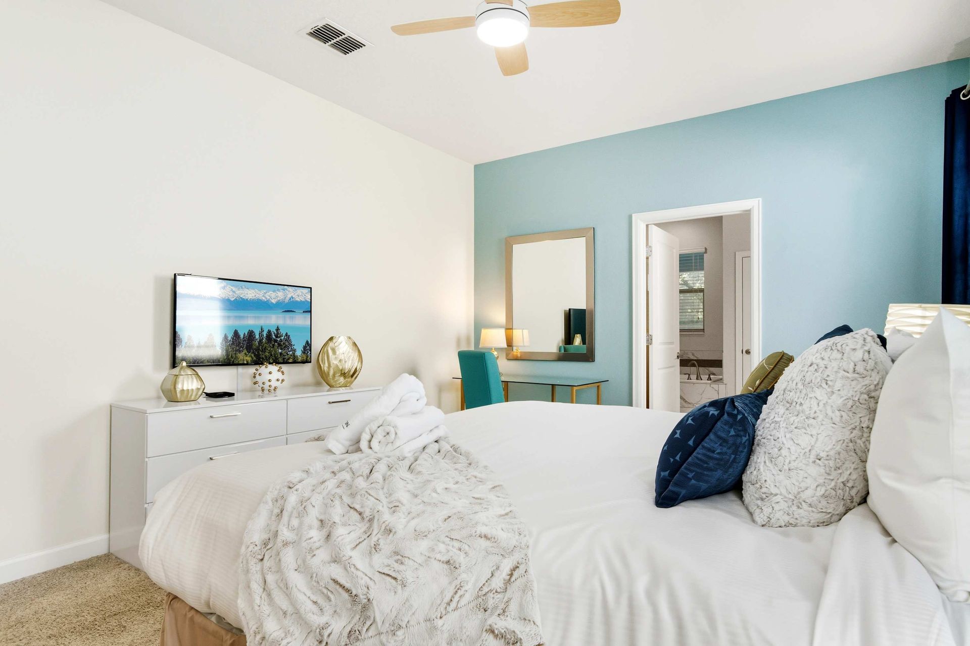 Comfy Queen bed, private vanity, and bright windows for natural light.