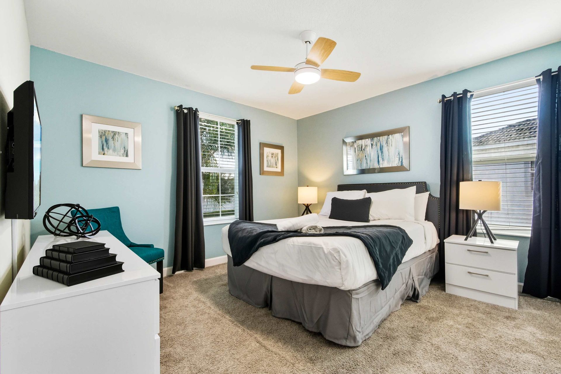 Coastal-modern chic with vibrant teal chair and natural light.