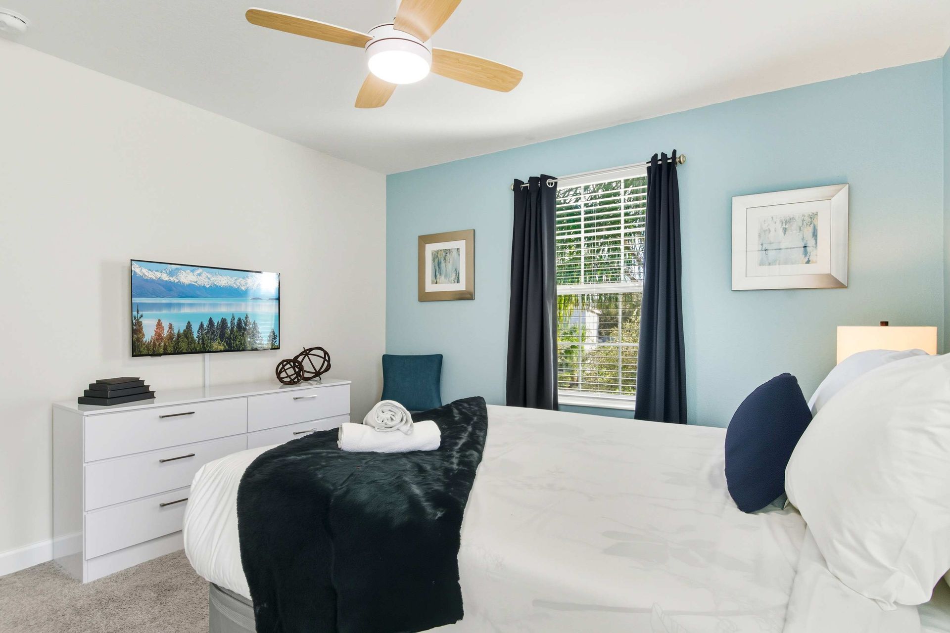 Bright, cozy Queen suite with ample light and ceiling fan.