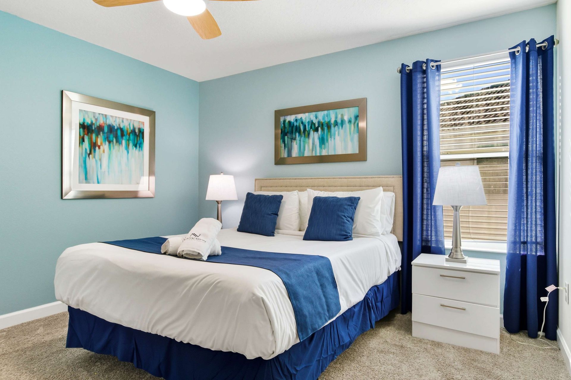 Serene King suite with cool blue walls and crisp white linens.
