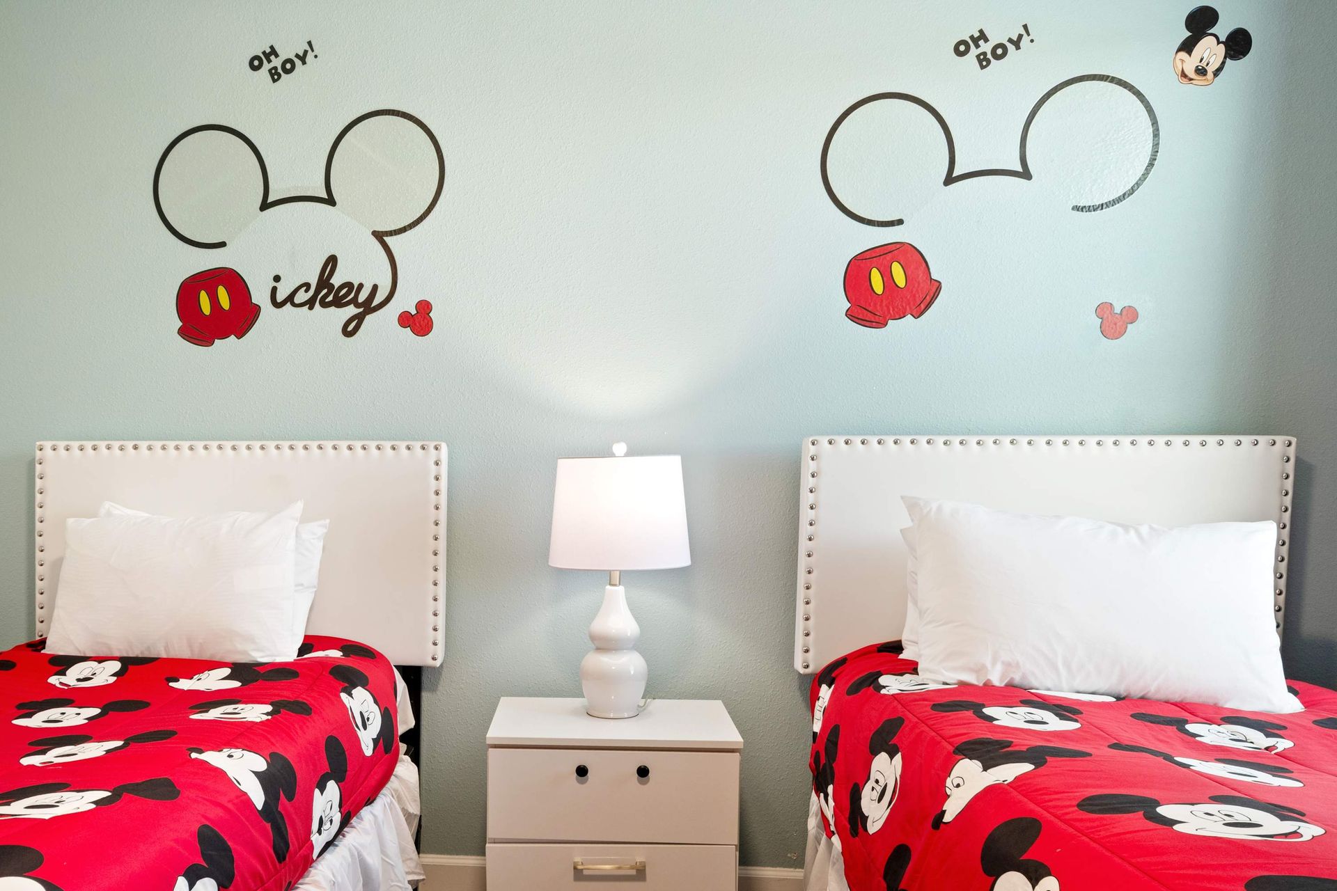 Bright blue walls and bold character art make this room a dream!