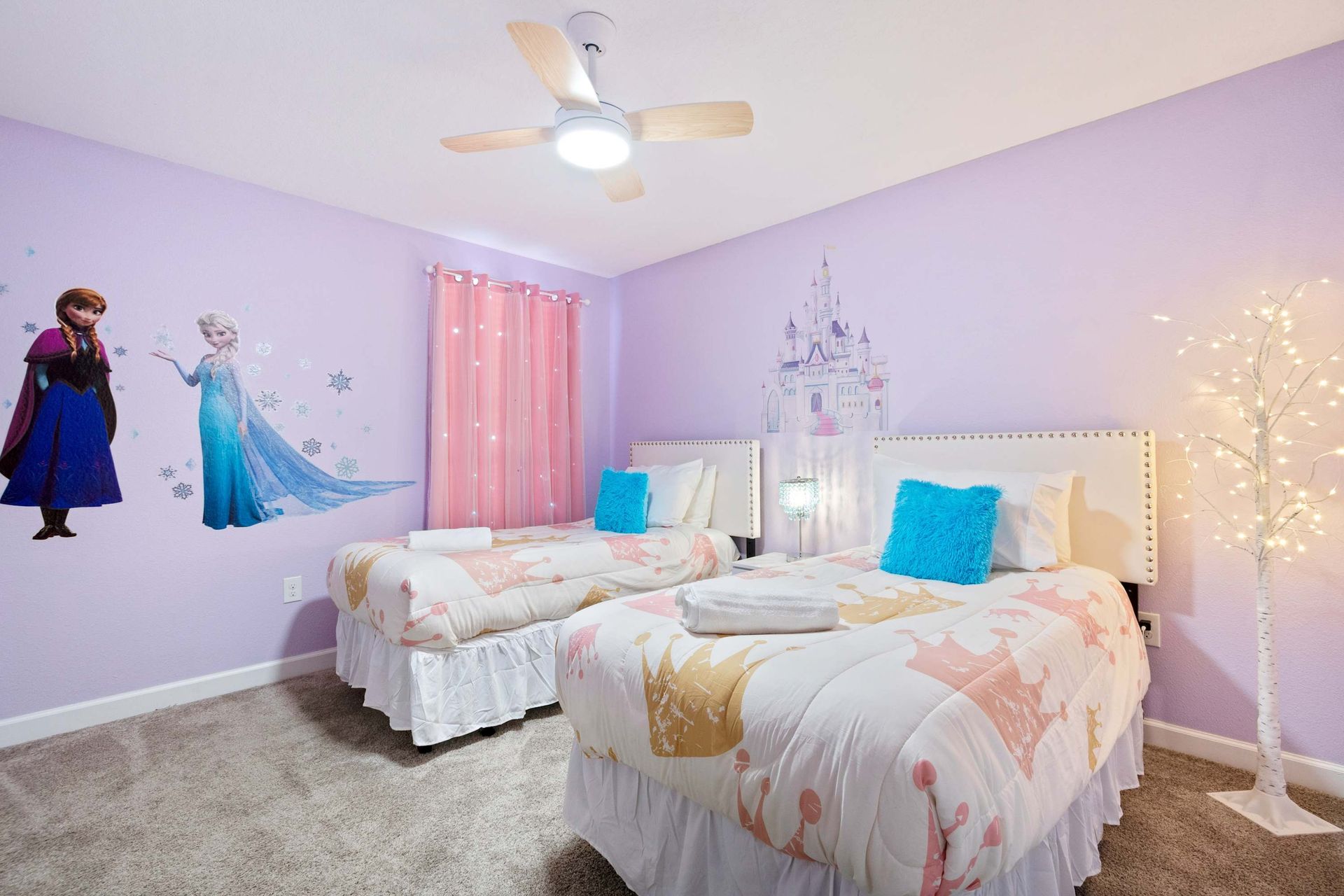 Twin beds in a magical themed room with character decals.