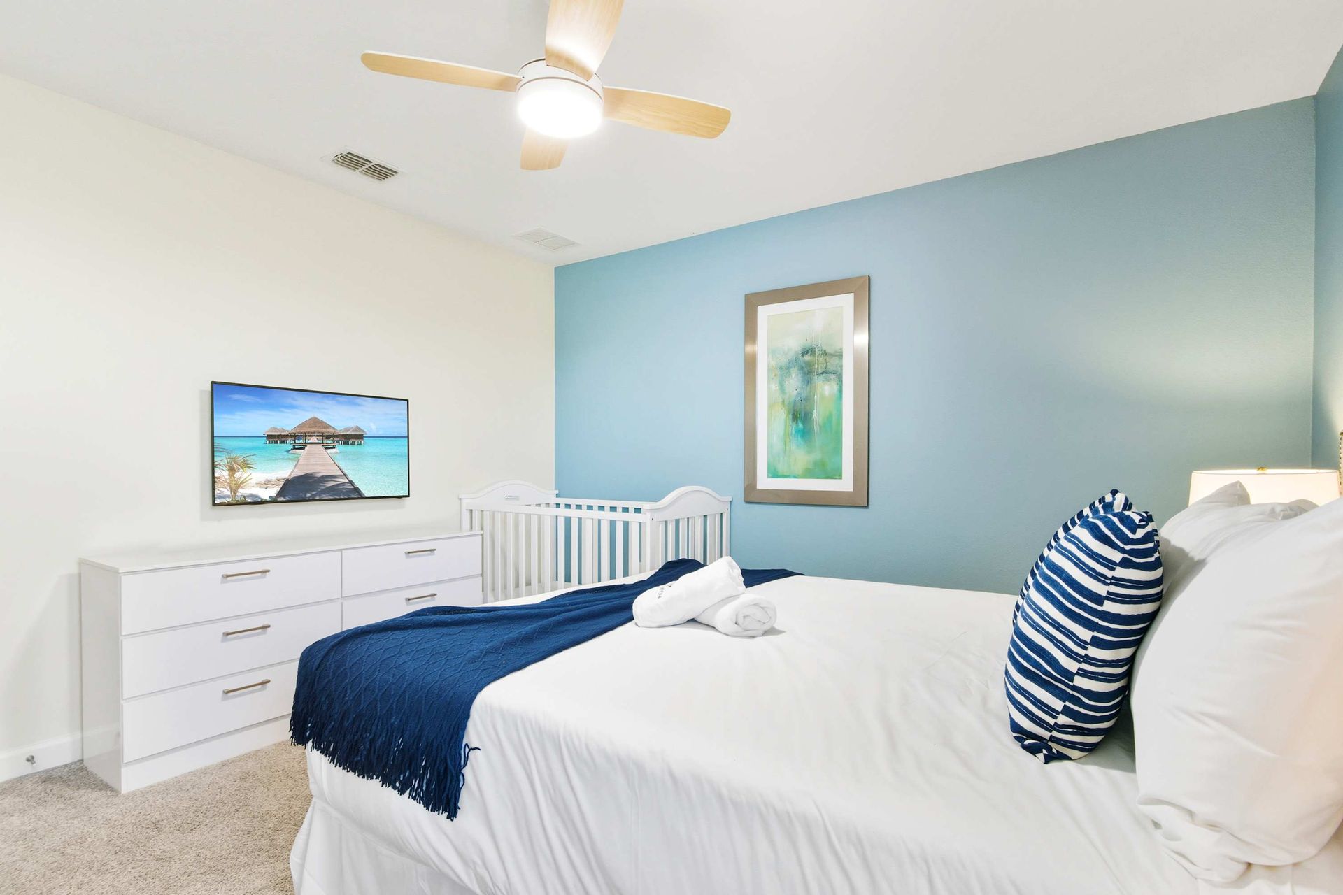 Peaceful Queen room, beautiful art, and baby-ready crib.