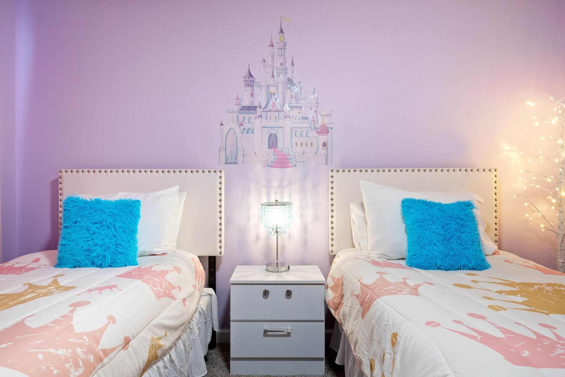 Fun lilac bedroom with twin beds and favorite characters.