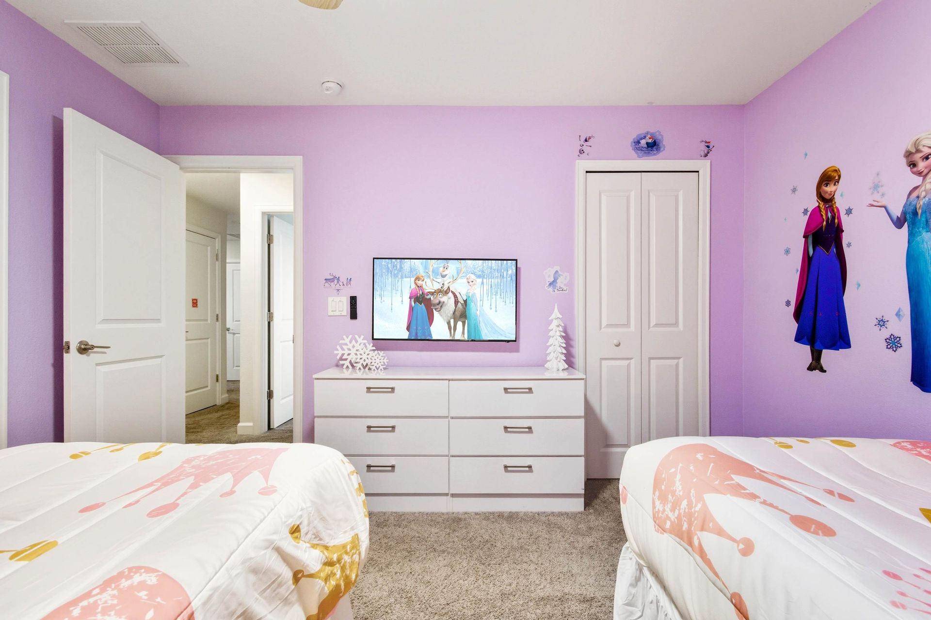 Cozy twin beds, large dresser, and flat-screen TV for movie night.