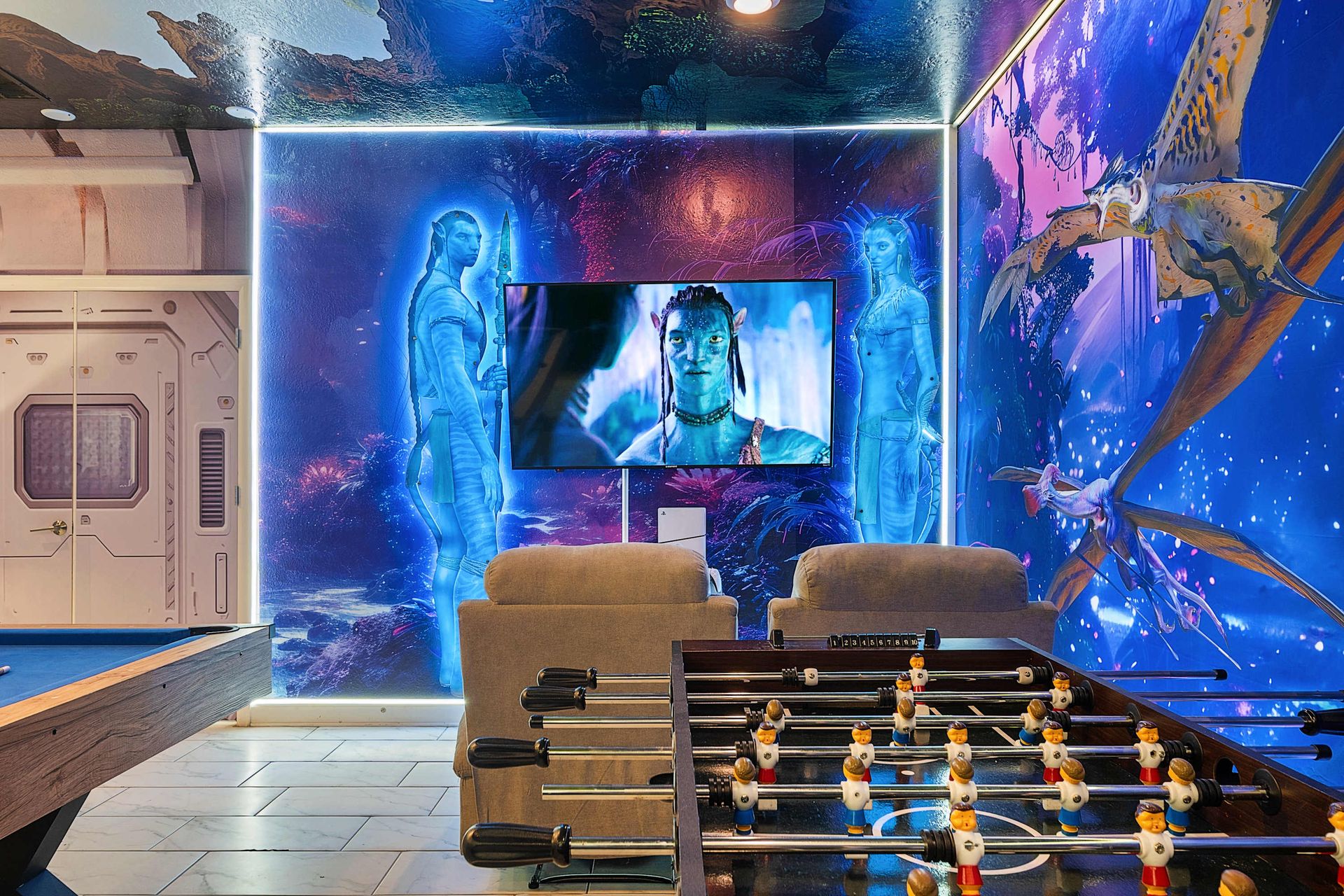 Vibrant wall art meets classic fun with a foosball table in this colorful, interactive corner that delights guests of all ages.