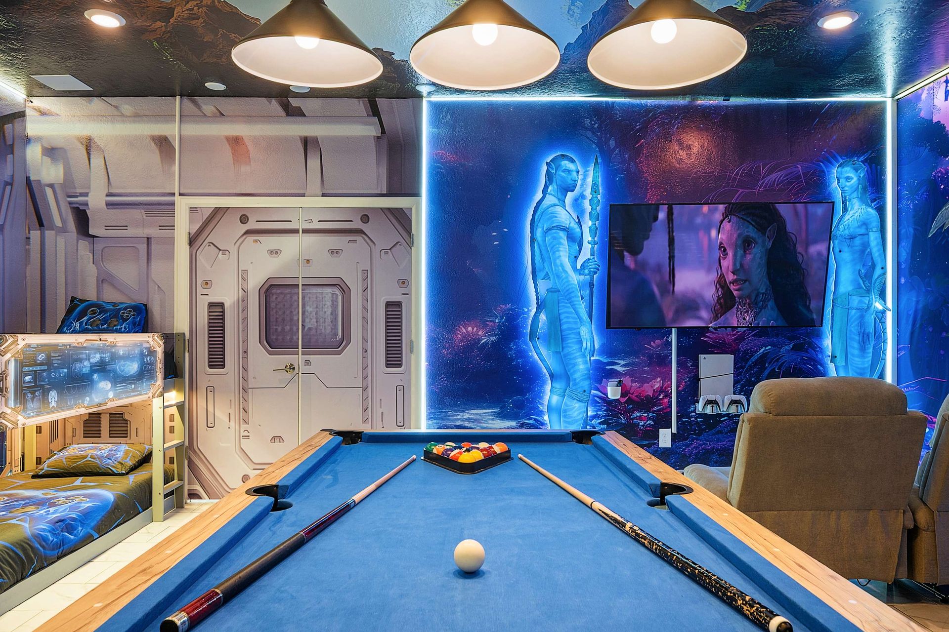 Challenge friends on the blue-felt pool table backed by breathtaking Avatar wall art and ambient lighting — perfect for fun photos and family tournaments.