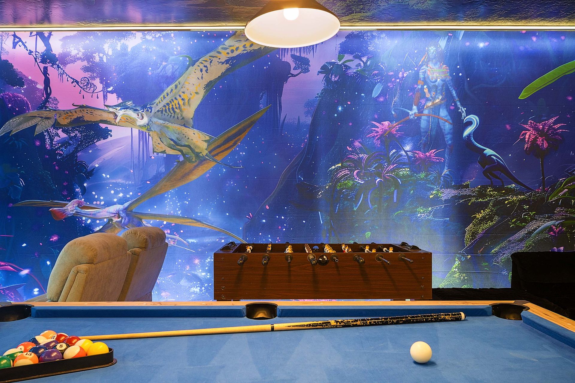 Enjoy the ultimate game room with recliners, foosball, and sci-fi bunk beds. The glowing ceiling mural and LED lighting create an unforgettable family experience.
