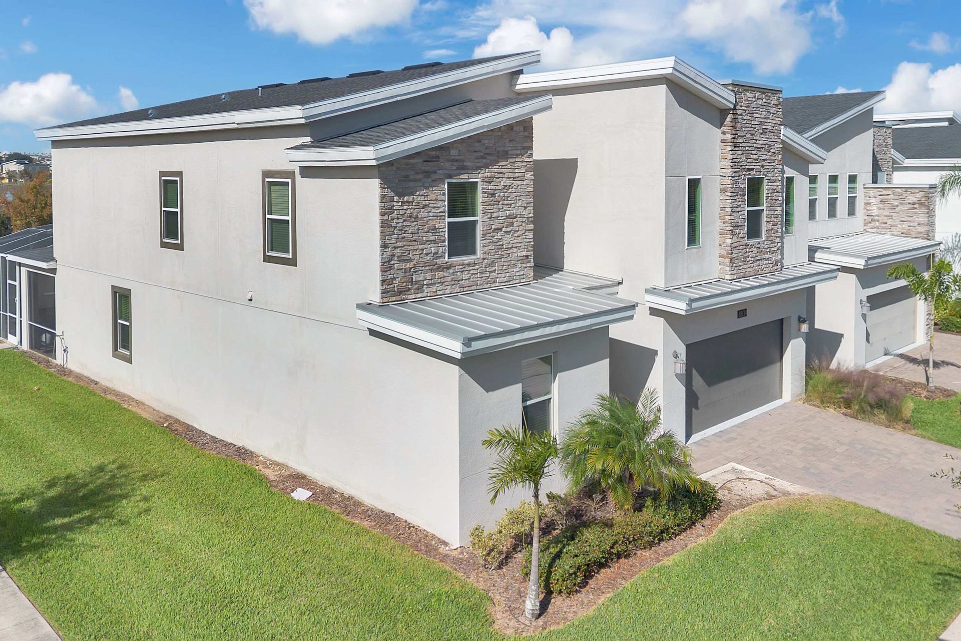 Modern Solana Resort villa exterior with stone accents, a garage, and private pool area.