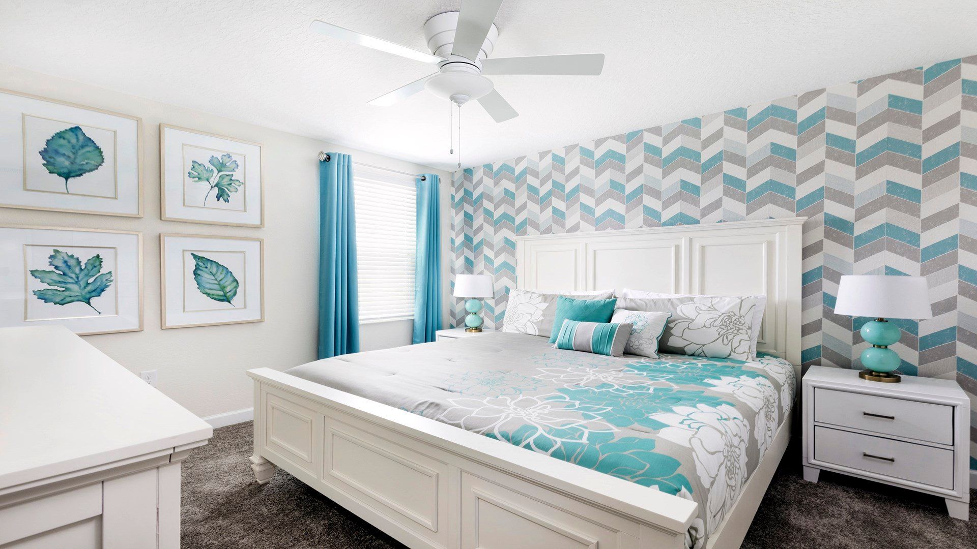 Bright bedroom with chevron wallpaper, pastel tones, and stylish decor