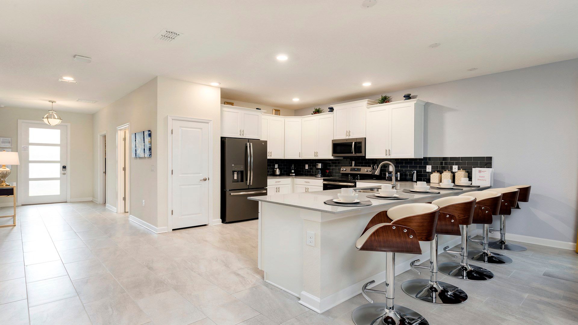 Spacious kitchen with island seating, modern appliances, and bright design