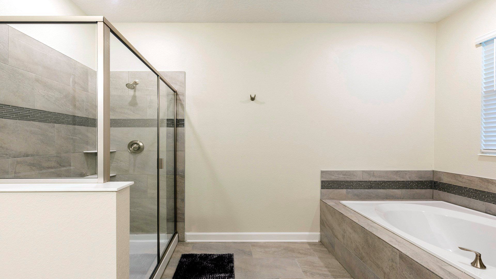 Bright bathroom with a full tub, modern vanity, and fresh décor.