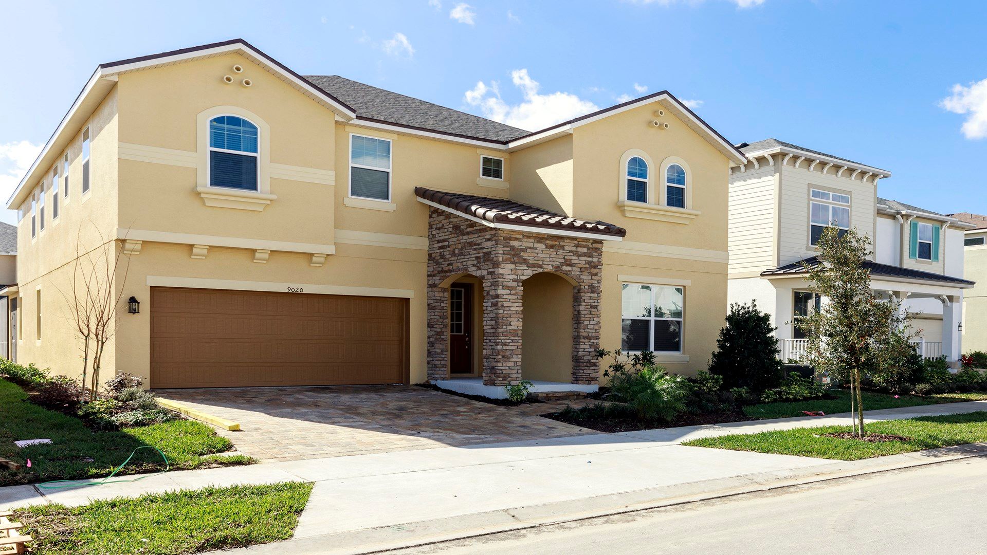 tep into a contemporary abode seamlessly blending modern aesthetics with nature, featuring lush greenery that harmoniously complements the architectural design