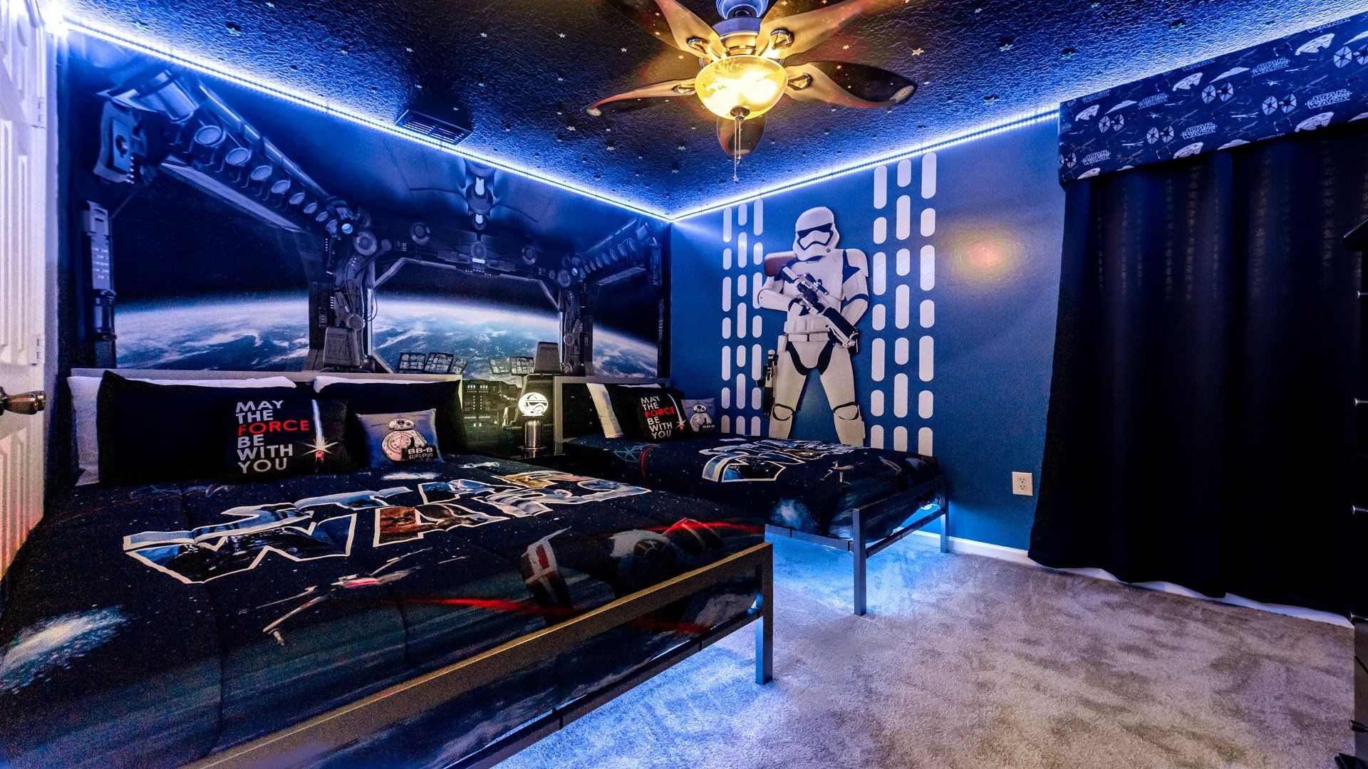 Children will delight in the immersive experience of this Star Wars-themed bedroom, adorned with captivating lights that transport them to a galaxy far.