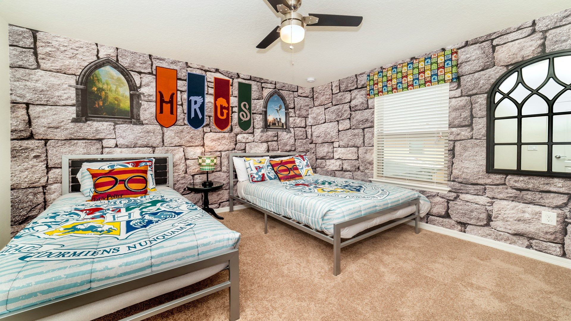 Magical twin room with themed decor, house banners, and castle-like walls.
