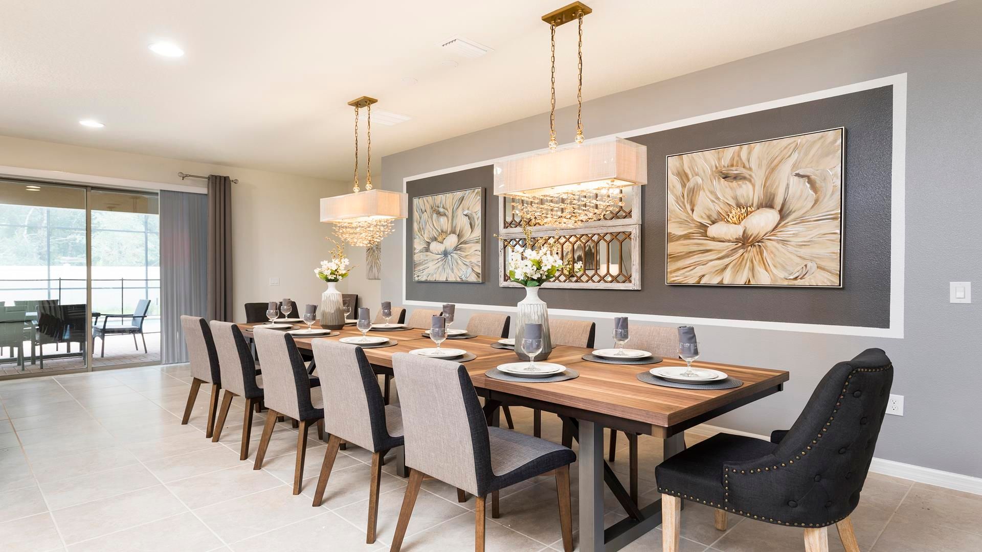 Stunning dining space with seating for 10, crystal chandeliers & floral art!