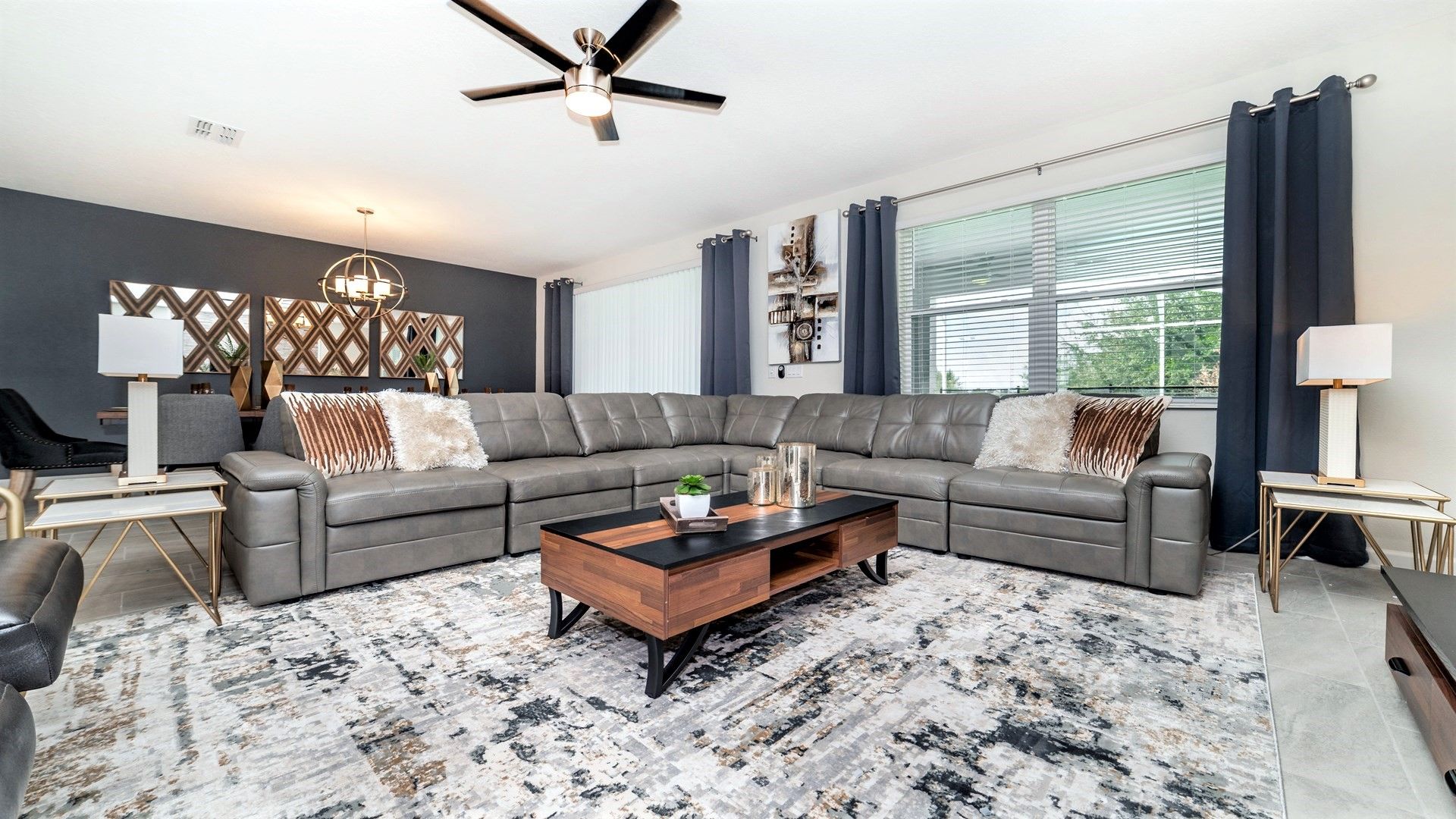 Spacious living room with plush seating, chic decor, and natural light!