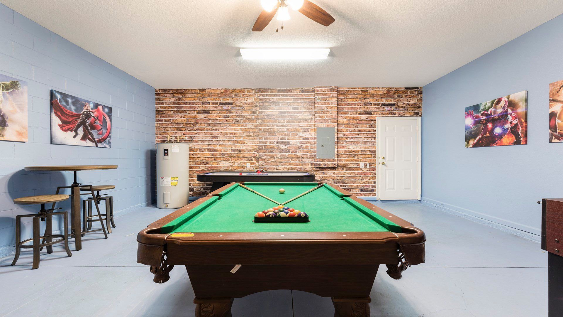the game room is stylishly furnished with a pool table, and a foosball. enjoy your fun time with friends and family