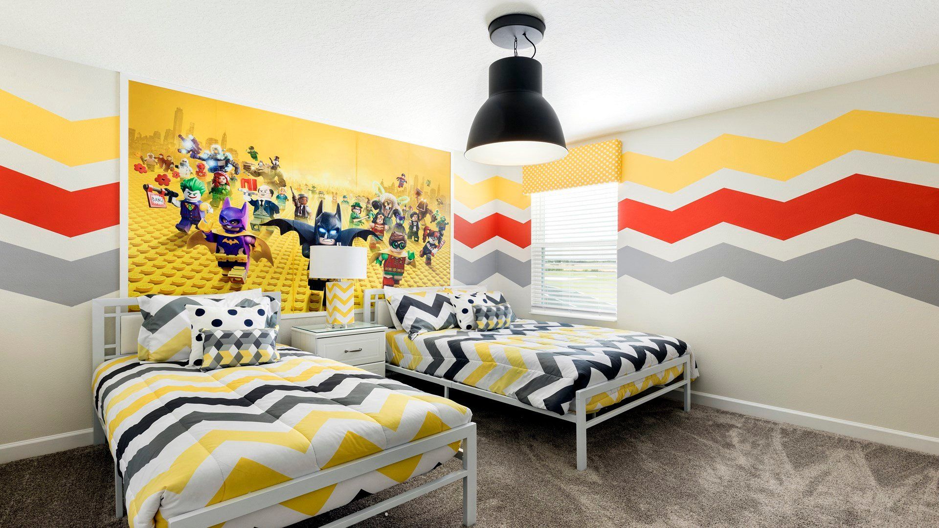 Bright LEGO-themed kids' room with twin beds and playful decor