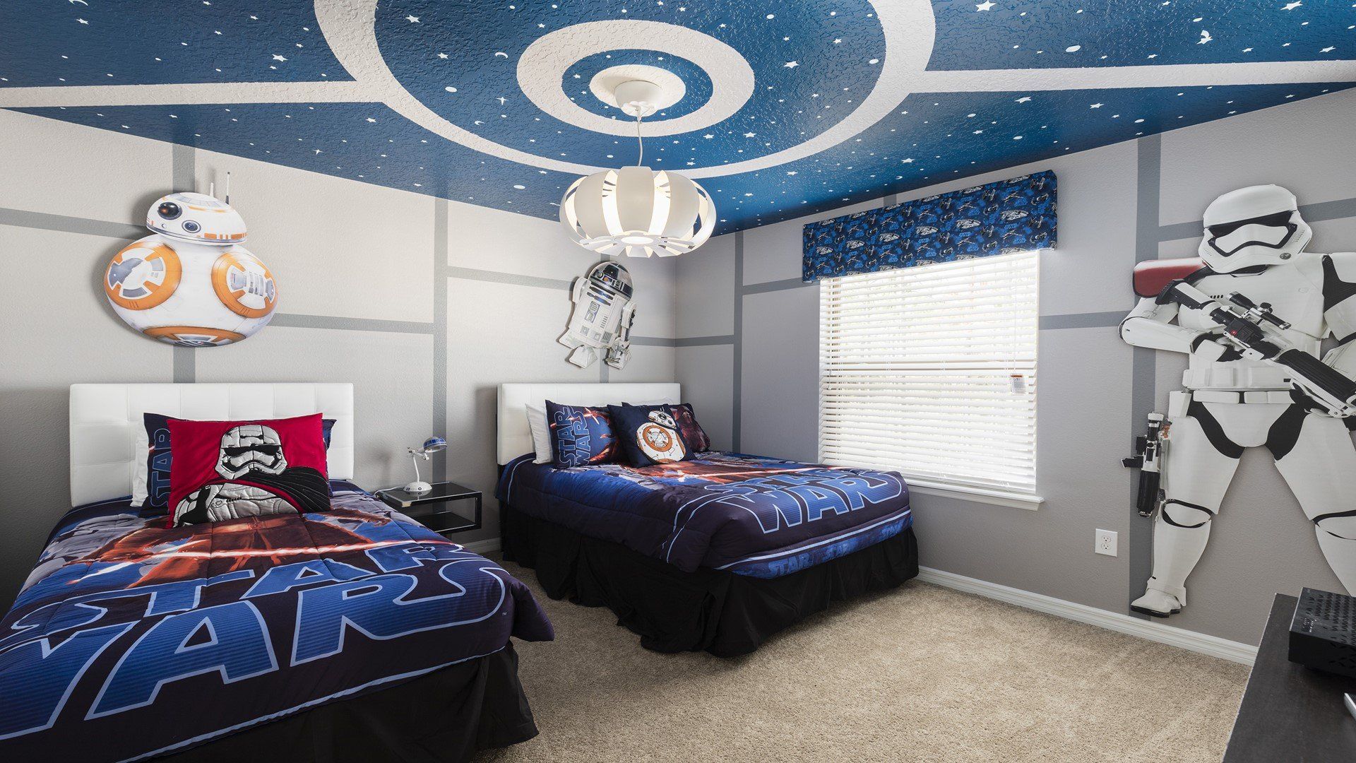 Star Wars-themed bedroom with spaceship ceiling, character cutouts, and twin beds for a fun adventure.