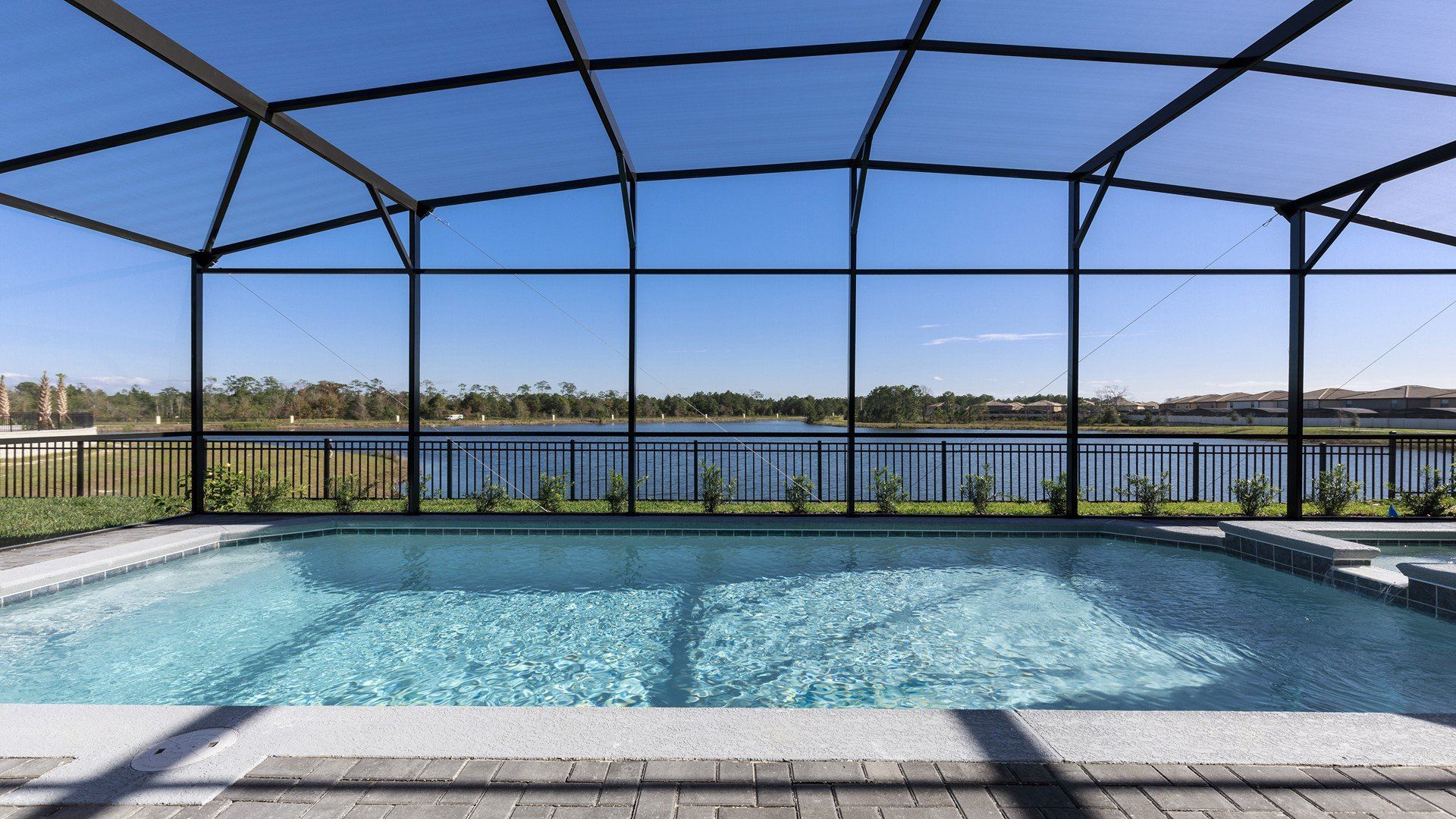 Dive into relaxation! Enjoy a sparkling pool with a serene lake view, perfect for a refreshing escape.