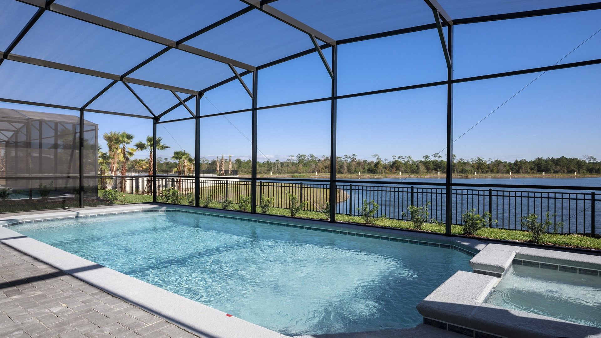 Refreshing pool with a scenic lake view, perfect for sunny days and peaceful relaxation.