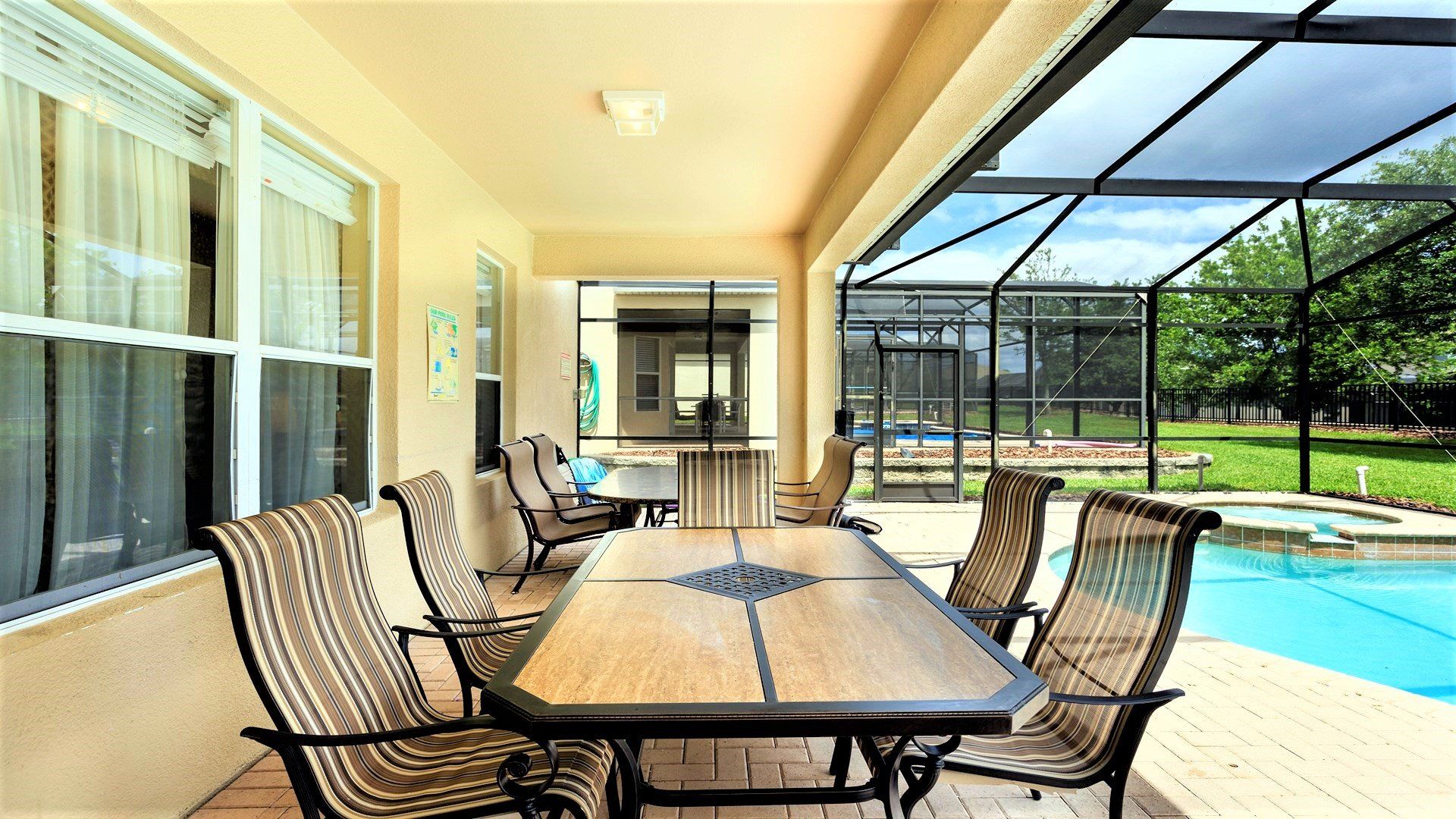 Screened-in patio with spacious outdoor dining, comfy seating, and a private pool!