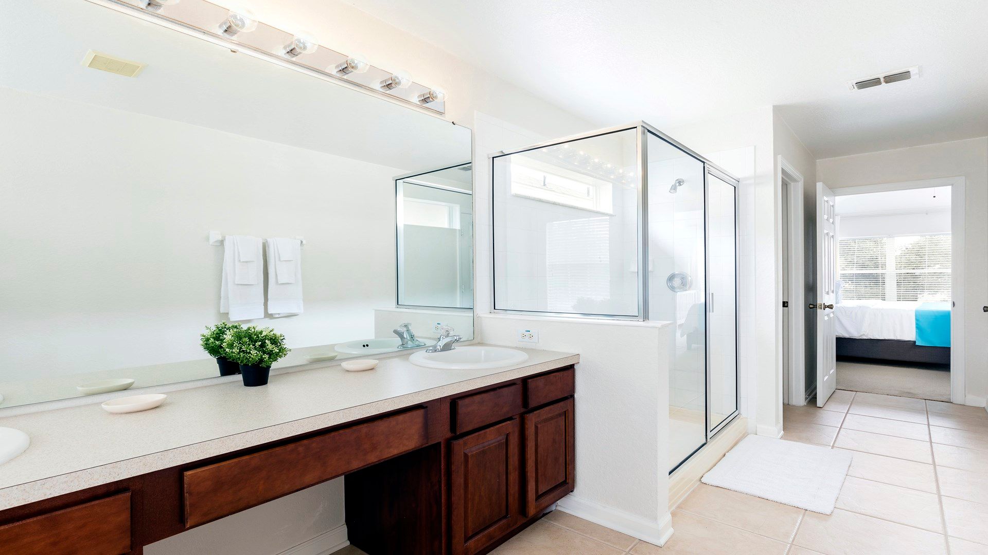 Spacious master bathroom with dual sinks, a glass-enclosed shower, and modern touches!