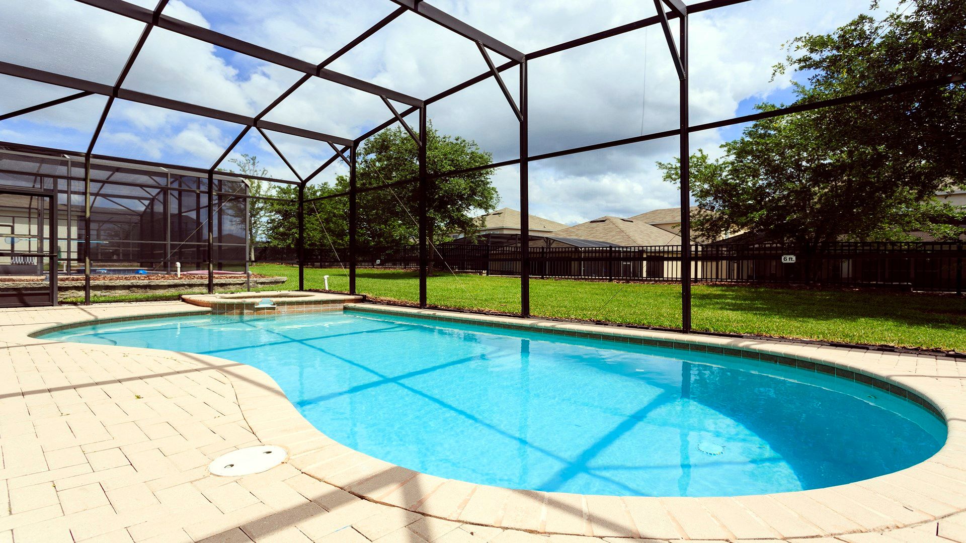 Private screened-in pool and spa with lounge chairs, outdoor dining, and sunny vibes!