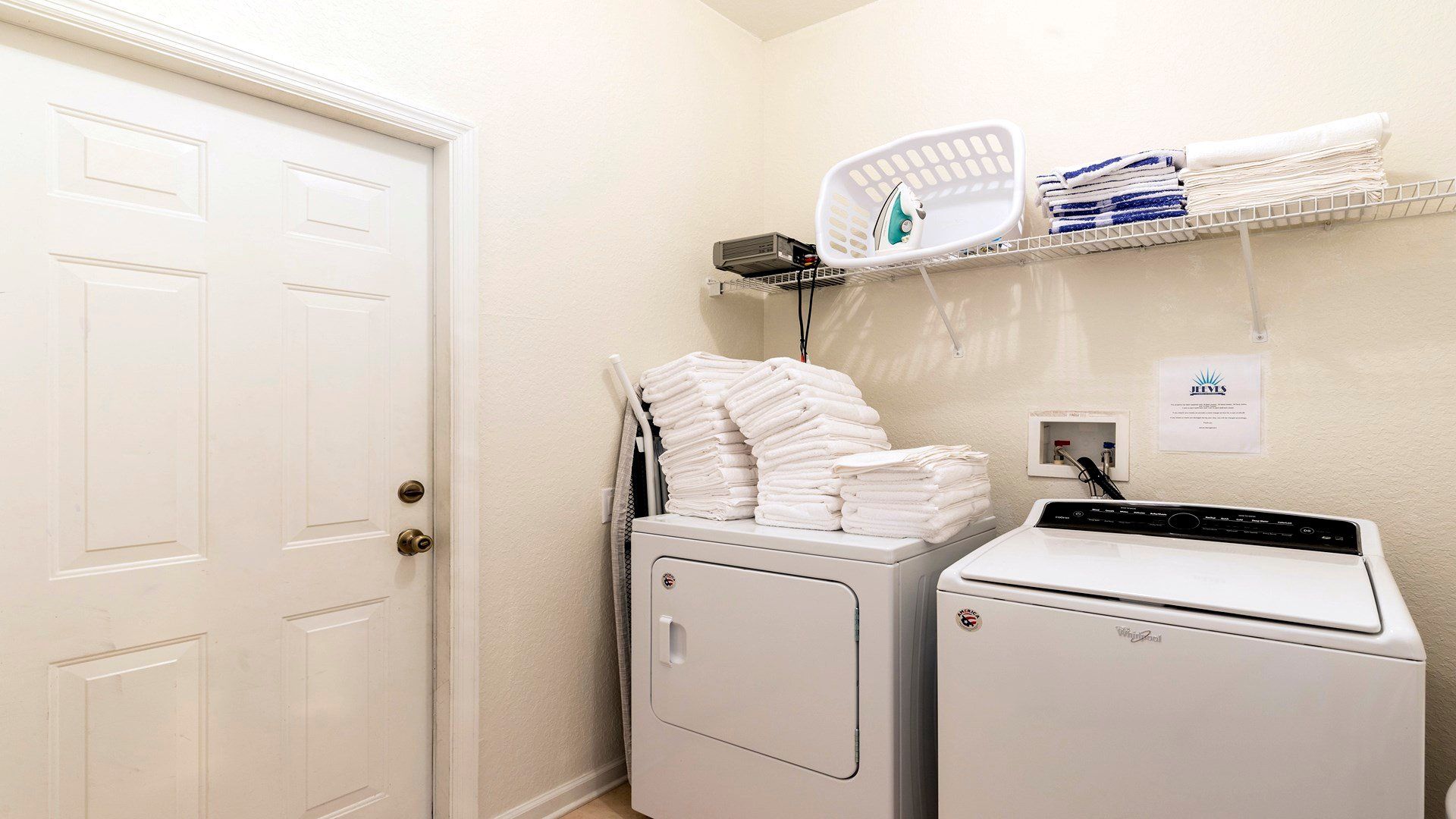Fully equipped laundry room with washer, dryer, fresh towels, and ironing essentials!