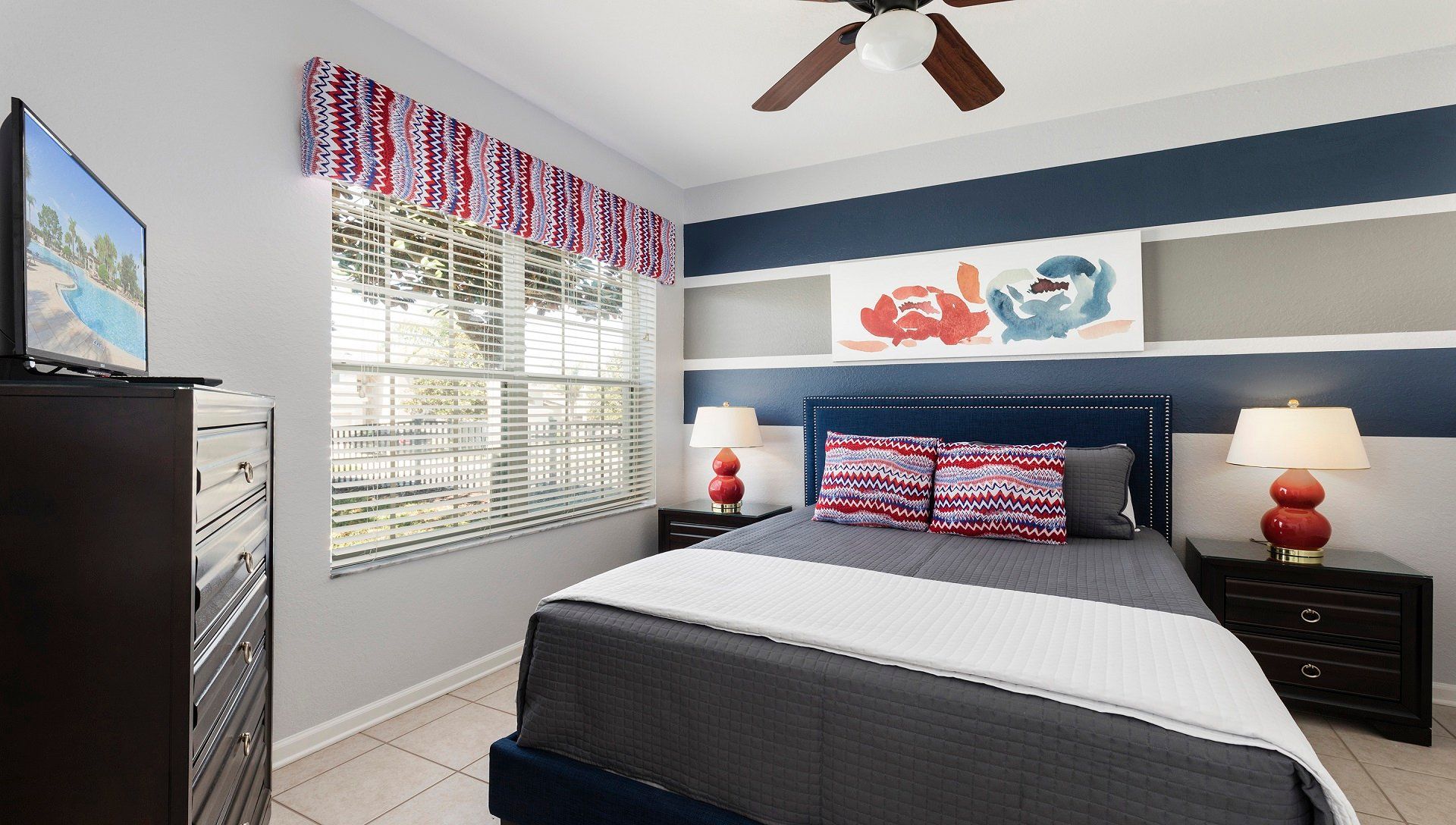 Stylish bedroom with bold accents, cozy bedding, natural light, and modern decor.