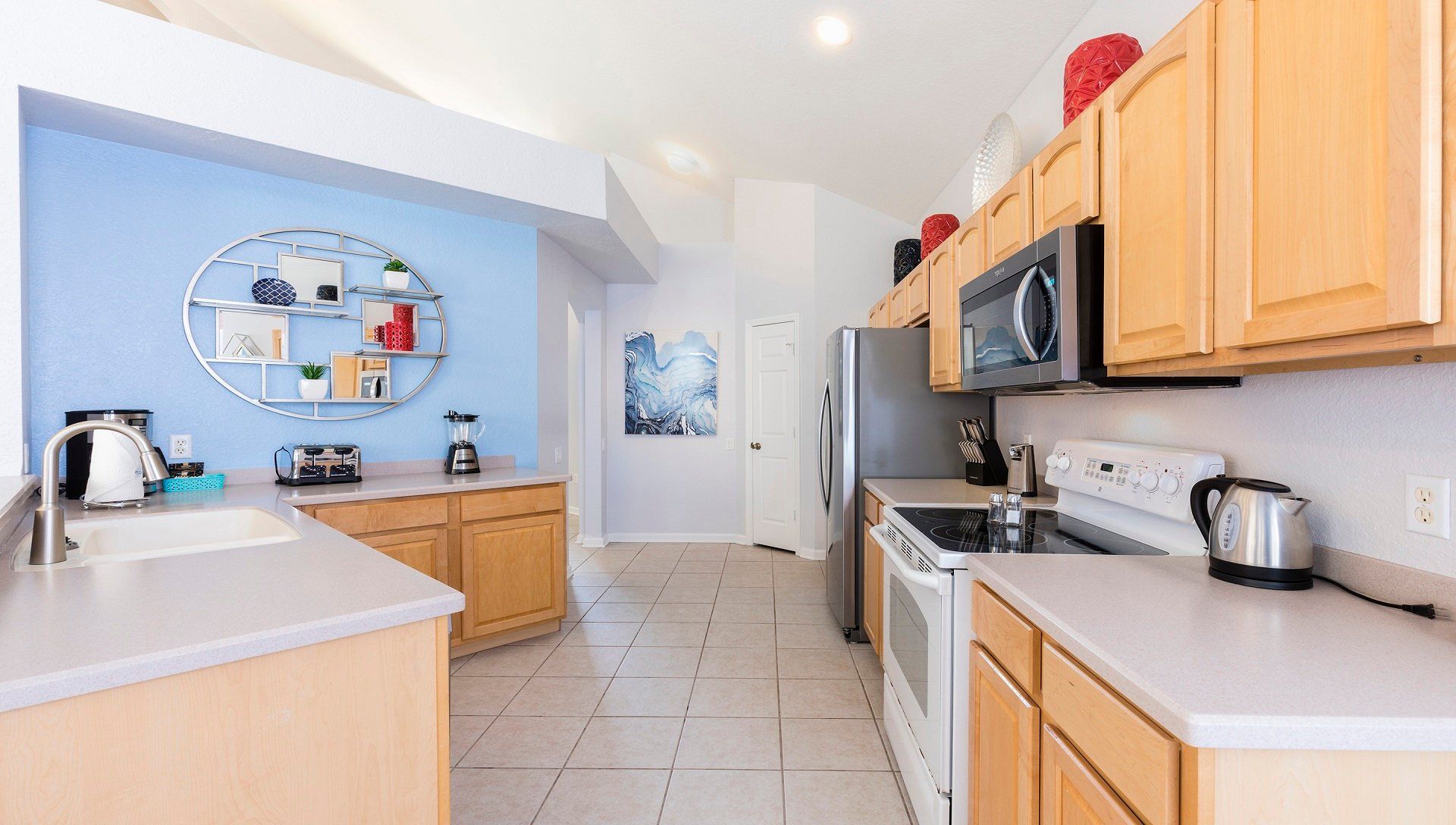 Bright, stylish kitchen with modern appliances, spacious countertops, and decor.