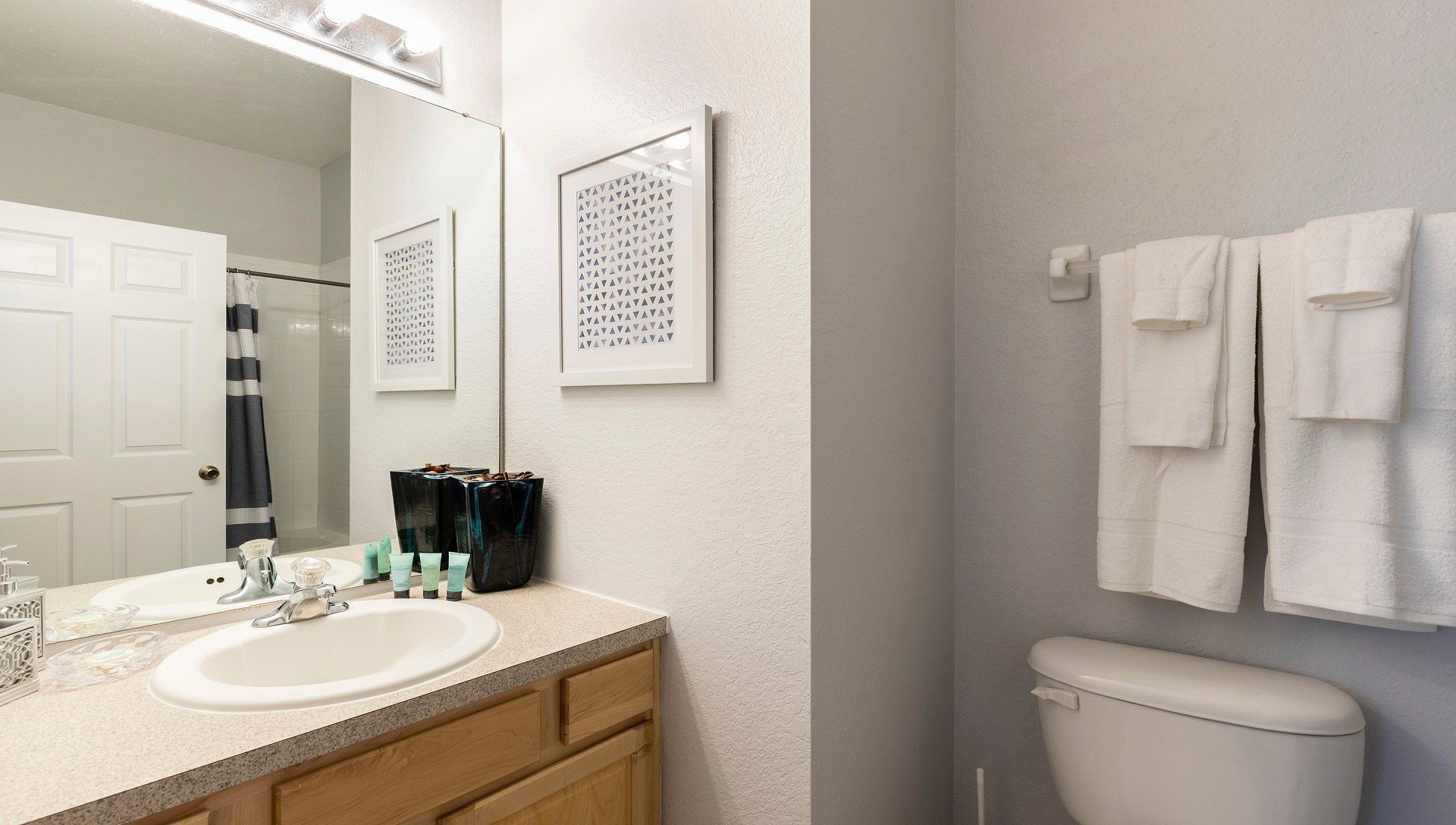 Modern and clean bathroom with fresh towels, stylish decor, and a relaxing shower.