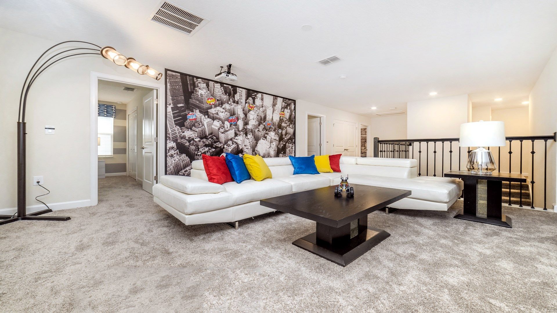 Spacious loft with cozy seating, vibrant decor, and cityscape vibes