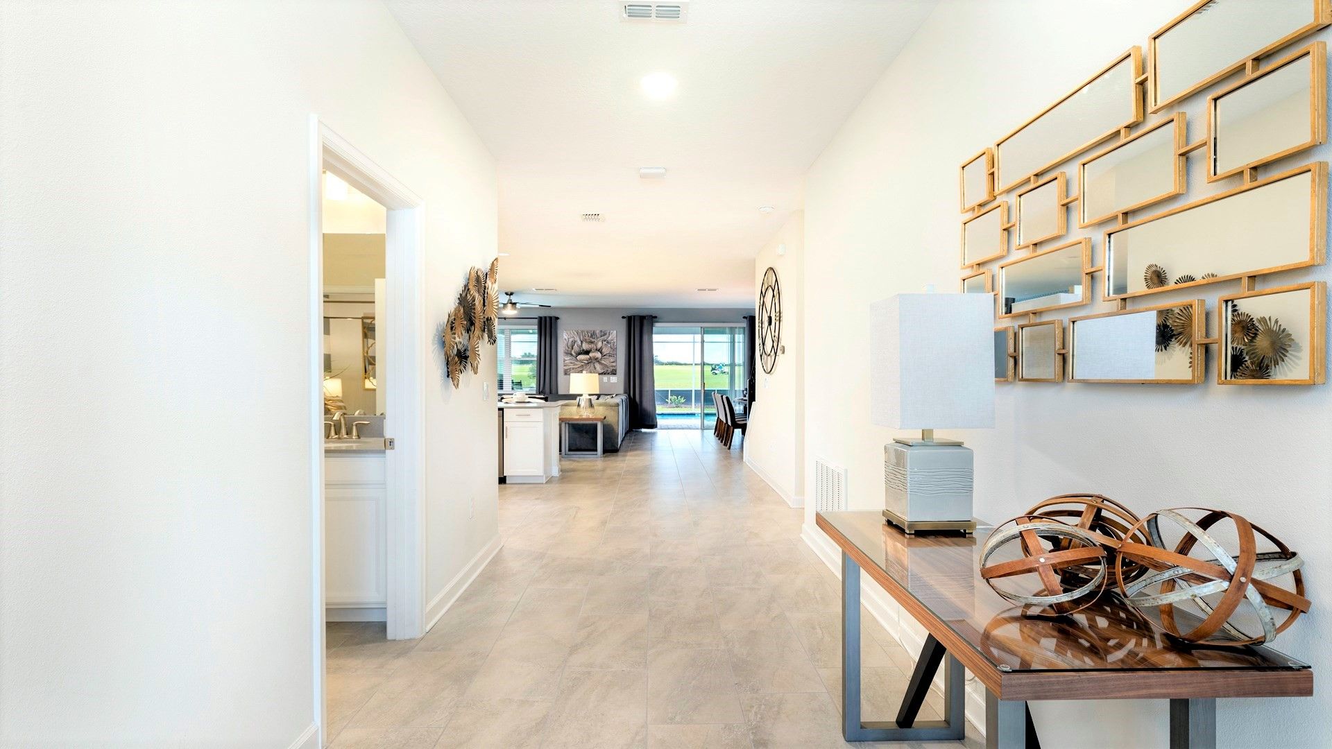 Bright entryway with modern decor, mirrored accents, and open layout