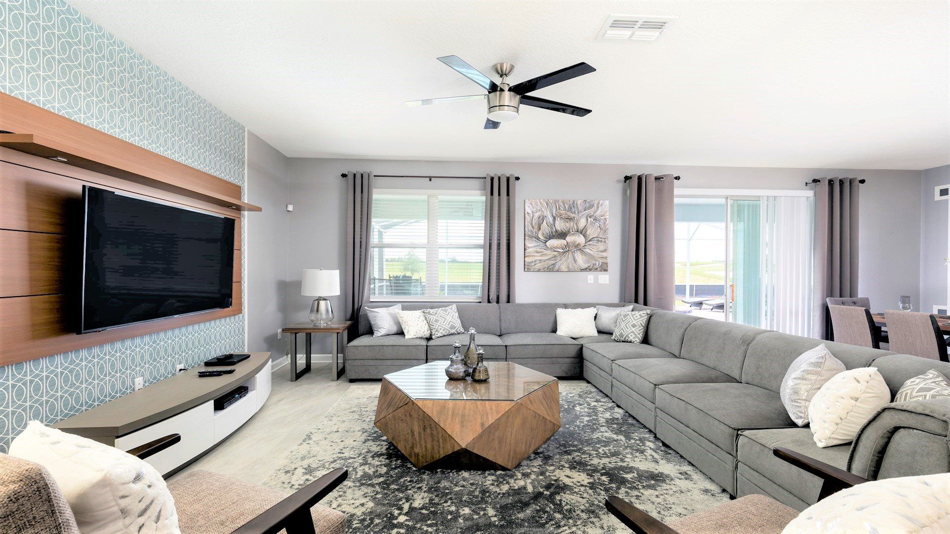 Spacious living room with comfy sectional, modern decor, and big TV