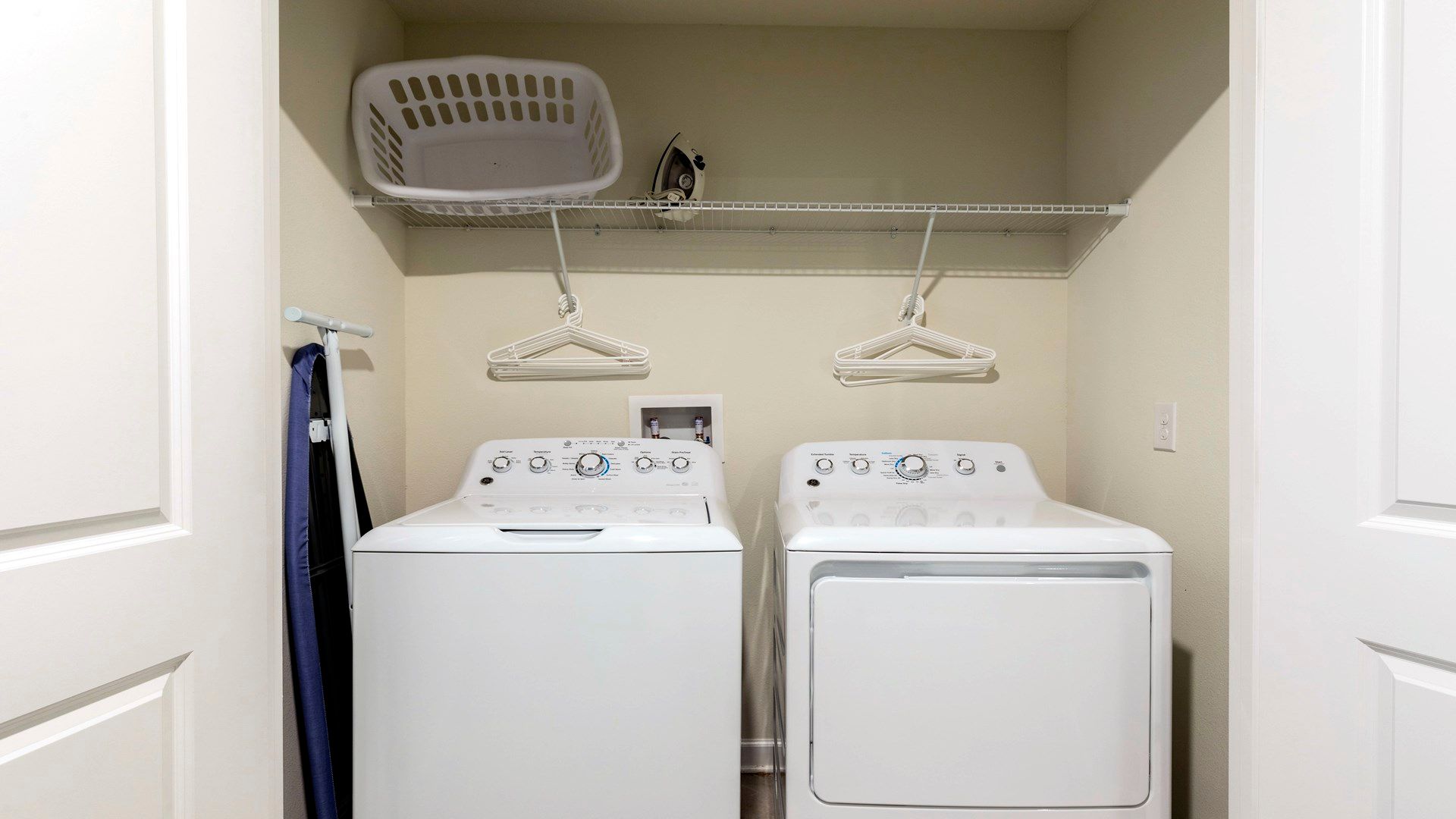 Convenient laundry room with washer, dryer, and storage shelf