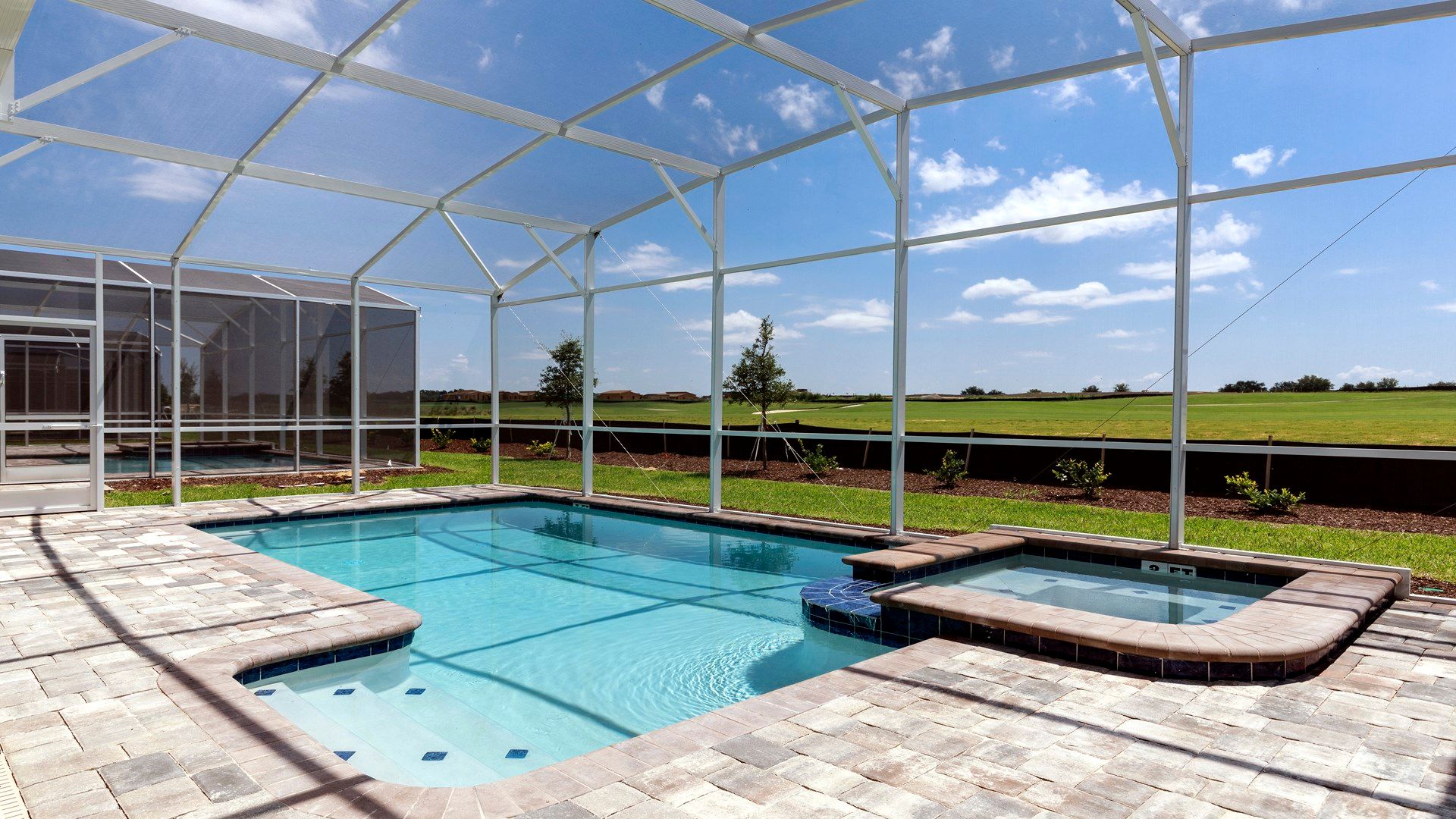 Sparkling screened pool and spa with serene views of open greenery