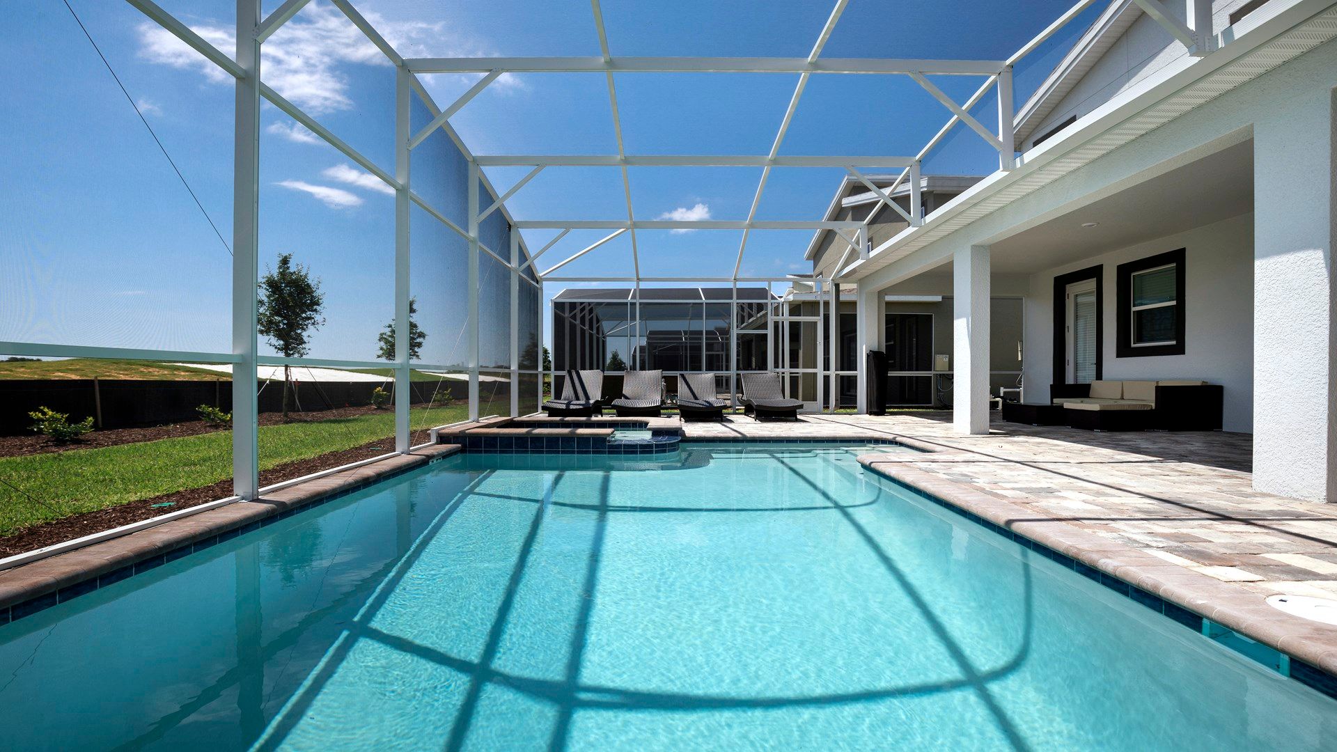 Relax in the screened private pool area with loungers and open views