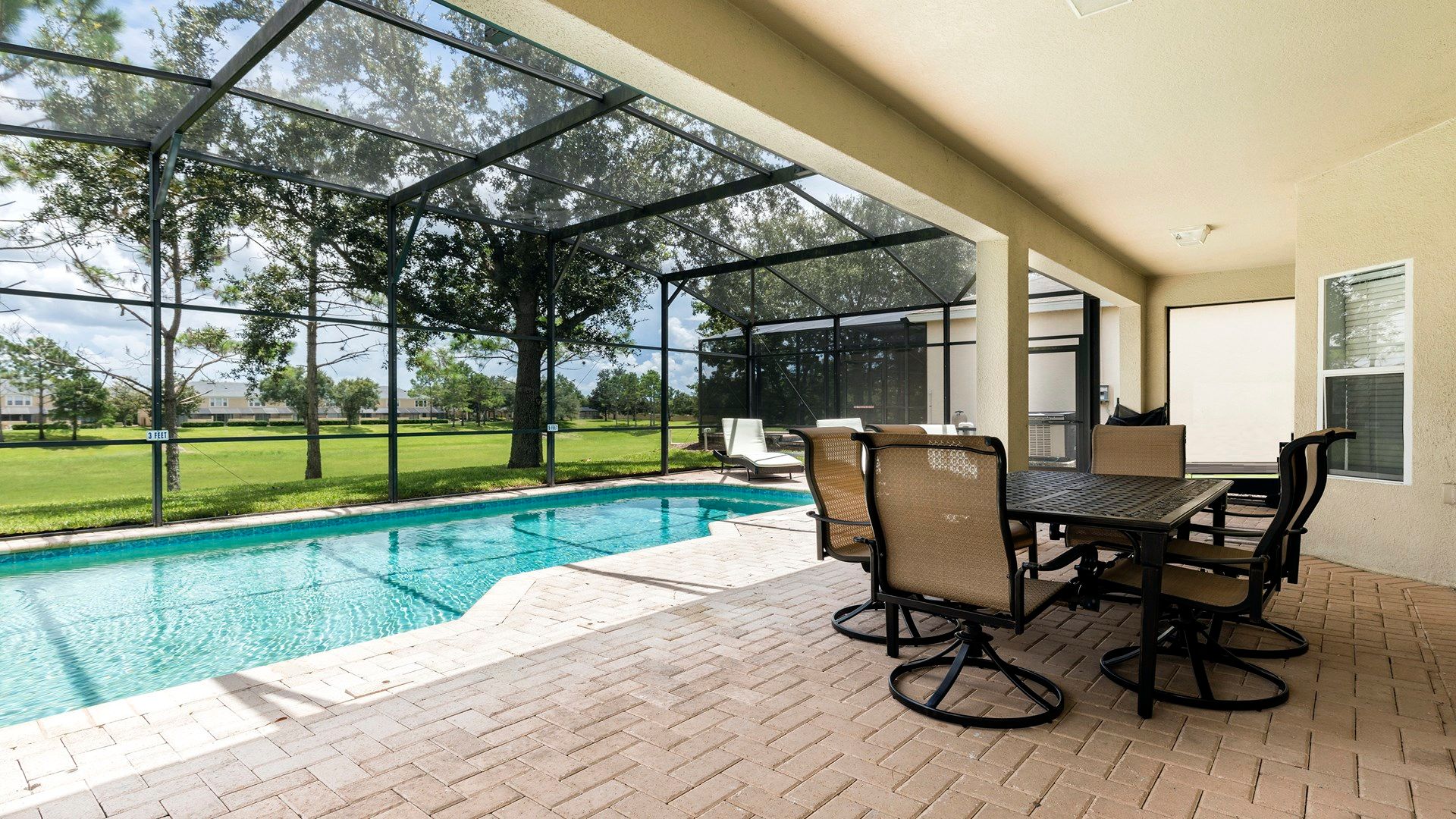 Enjoy outdoor dining by the private pool with serene views and a screened lanai!