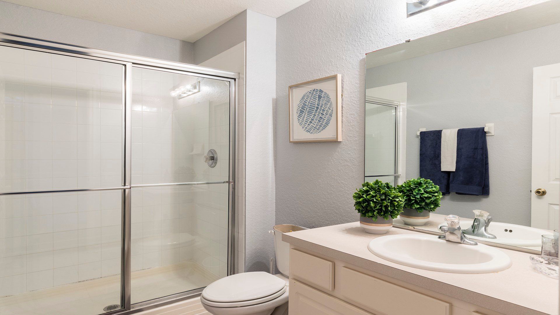 Modern and fresh bathroom with a spacious glass shower and elegant decor!
