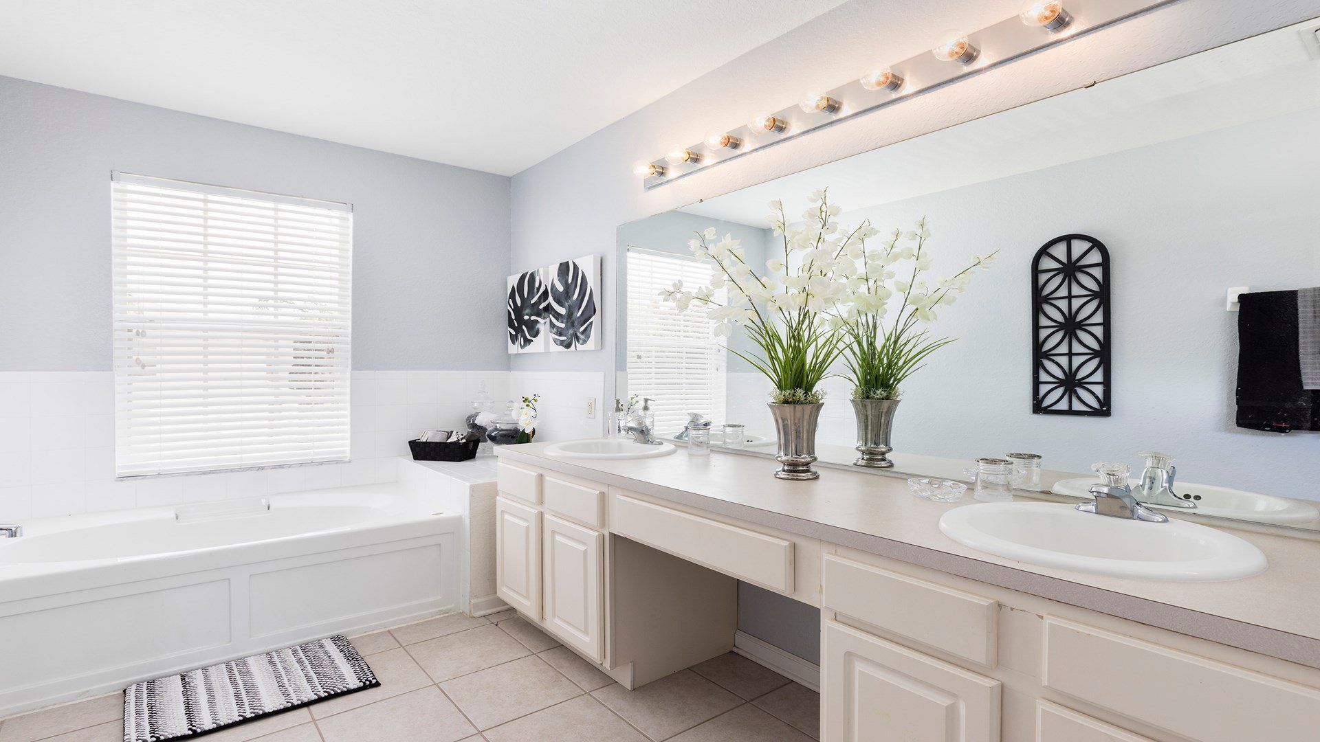 Bright and elegant bathroom with dual sinks, a soaking tub, and spa-like vibes!