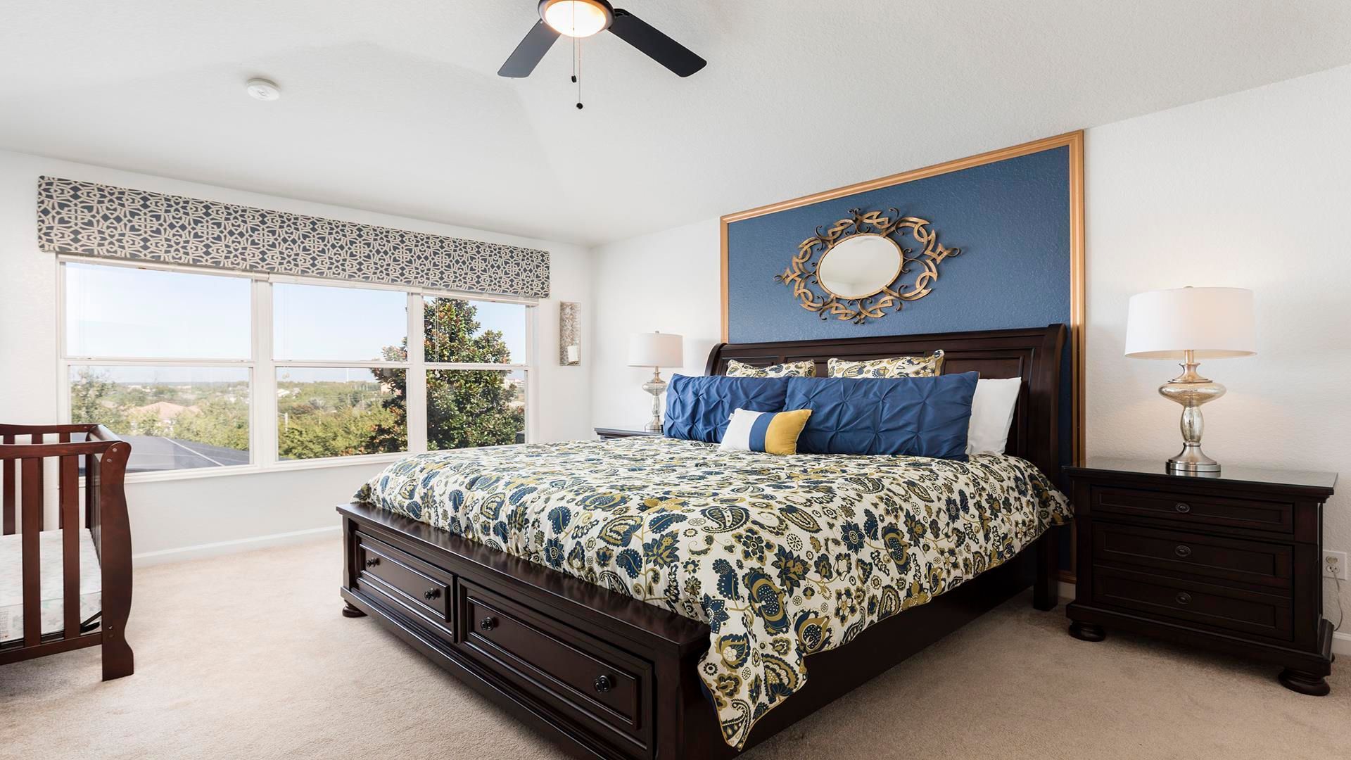 The spacious king bedroom on the second level with a crib.