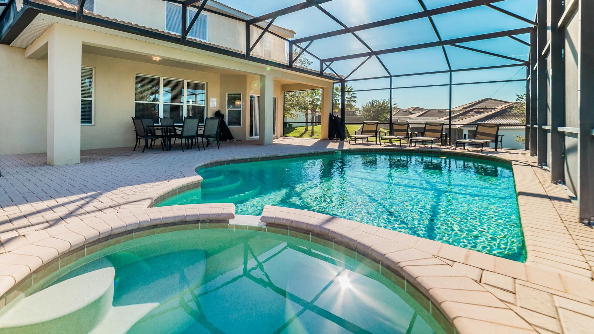 Private screened pool with spacious deck, perfect for outdoor dining and relaxation.