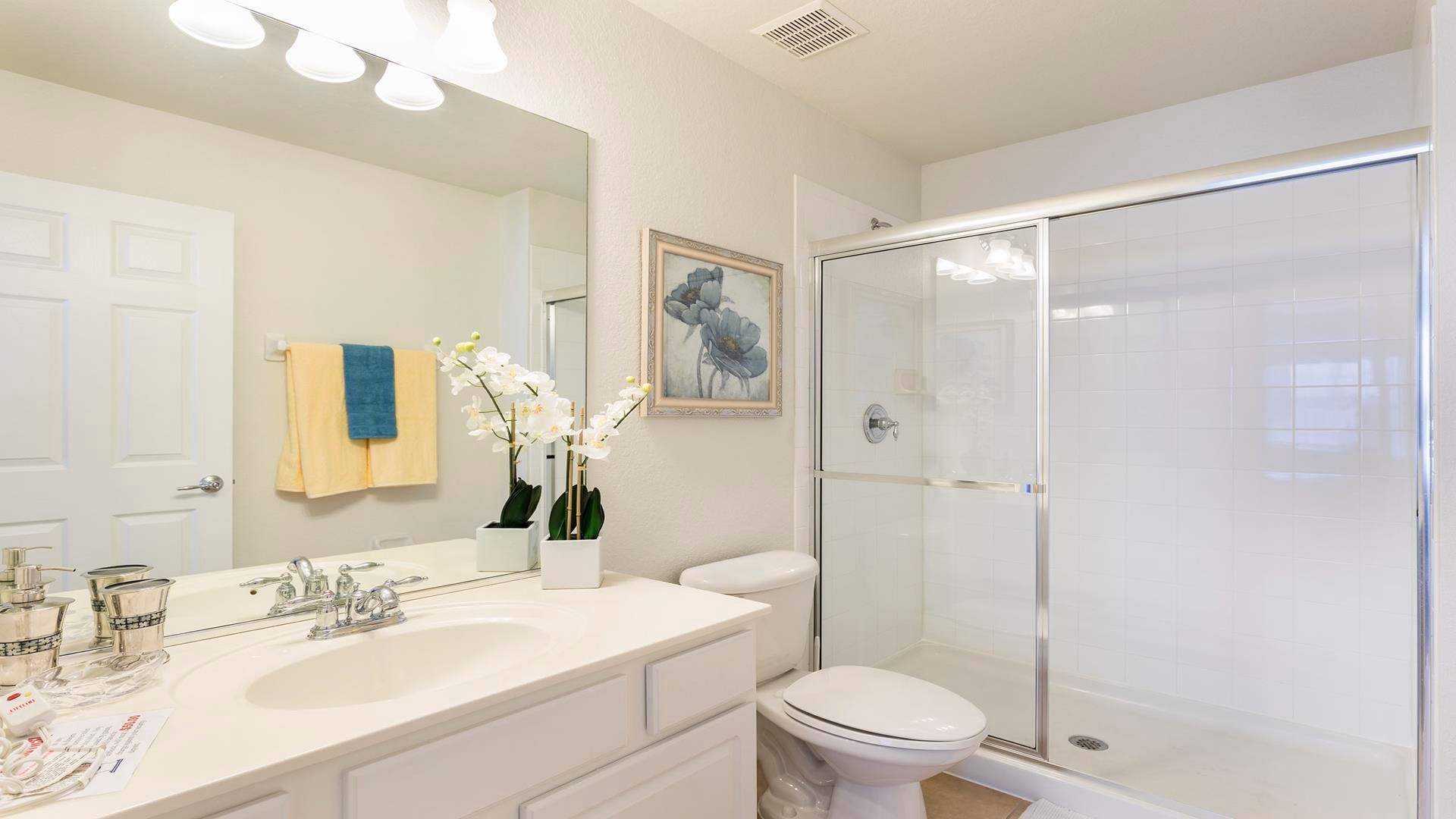 Modern bathroom with clean lines, sleek shower, and decorative accents.