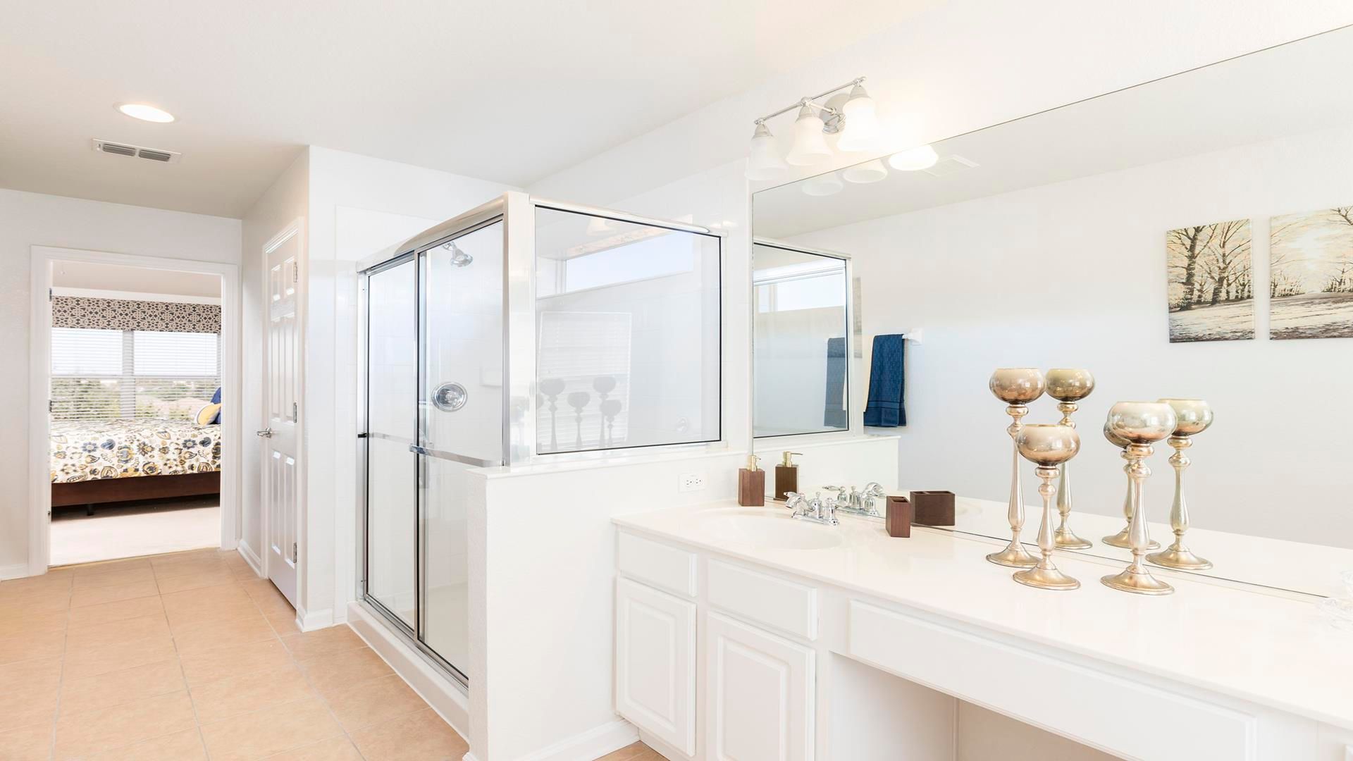 Bright and airy bathroom with modern fixtures, sleek shower, and elegant decor.